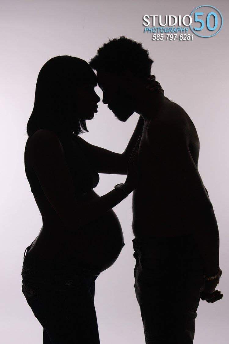 Silhouette series showing tender moments between expectant couple.