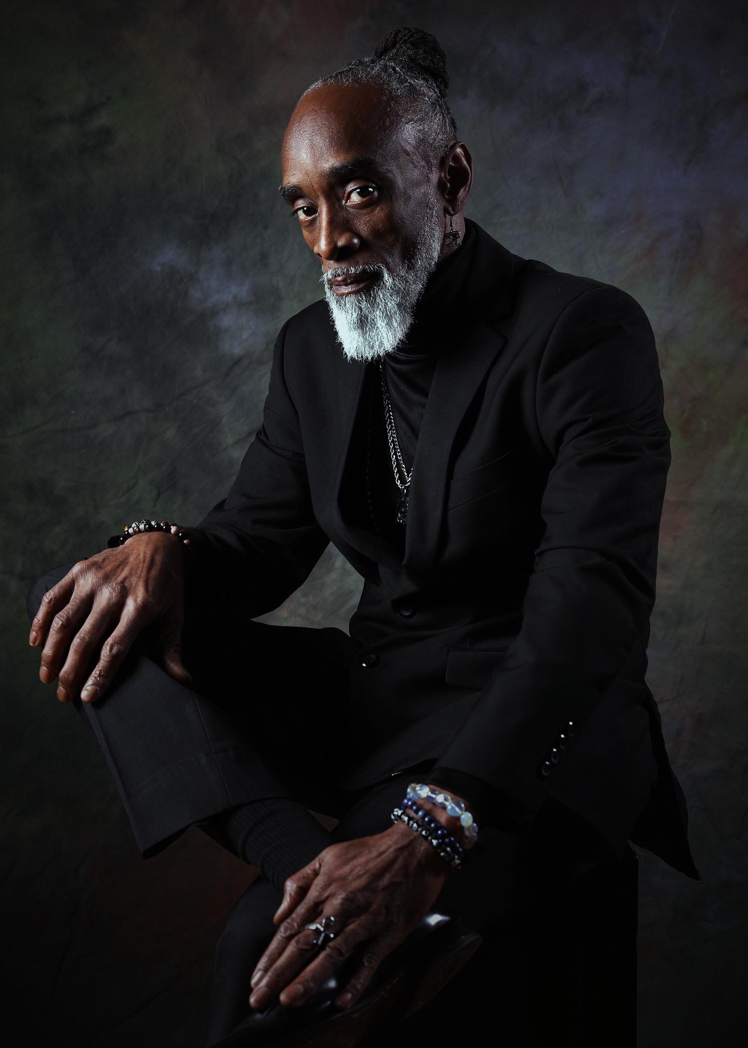 Dramatic series of portraits in dark lighting showing elegant poses in black attire.