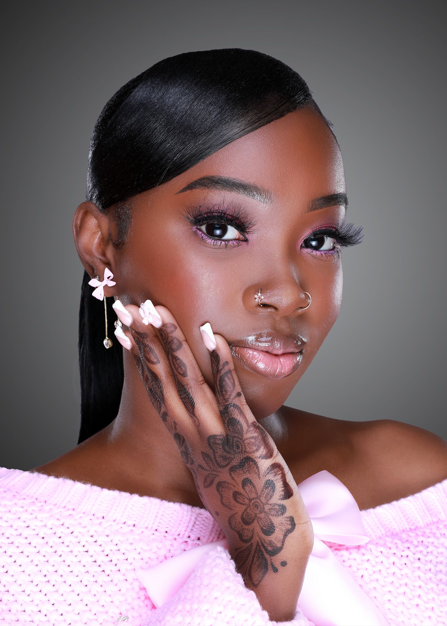 Glamour portrait series showing woman in pink top with tattoos against gray background.