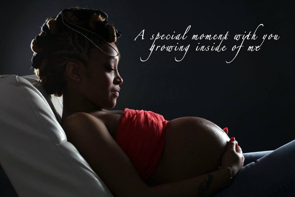 Silhouetted maternity portrait with inspirational text overlay on dark background.