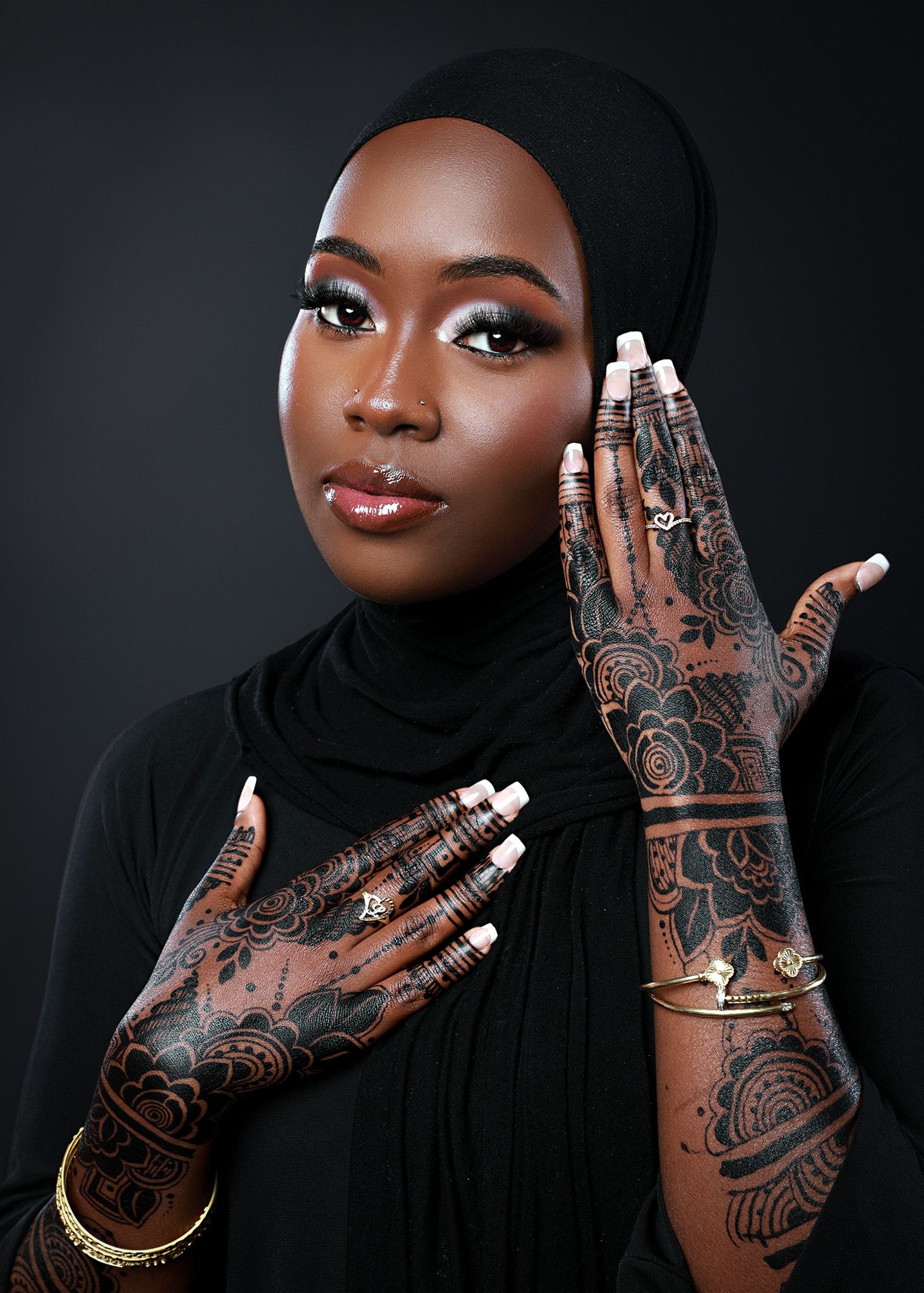 Close-up shots showcasing intricate henna designs on hands against dark background.