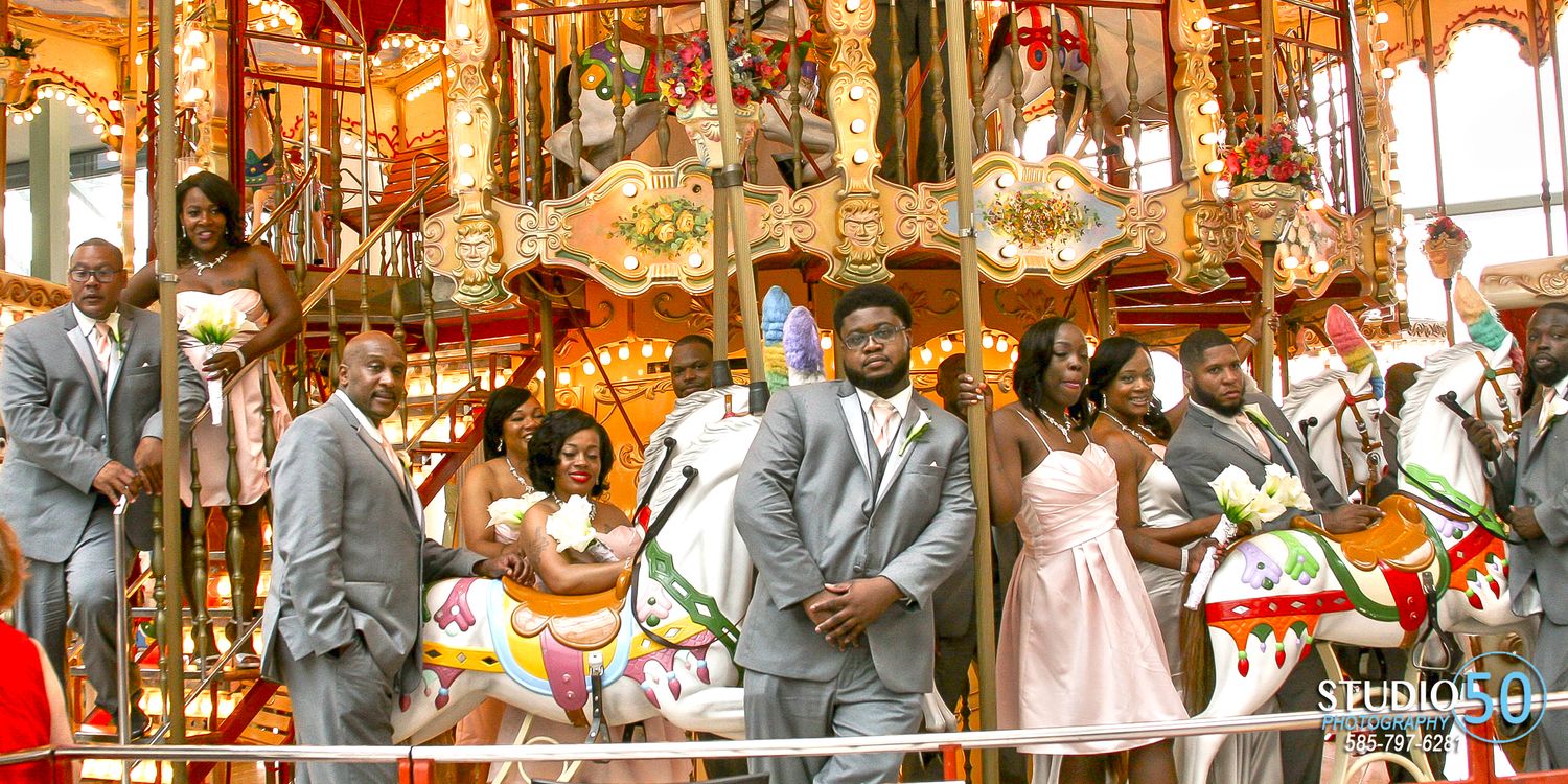 Wedding party celebration at a carousel with warm lighting and festive atmosphere.