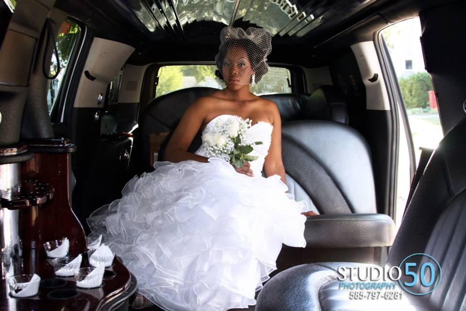 Wedding day transportation scene inside a decorated vehicle.