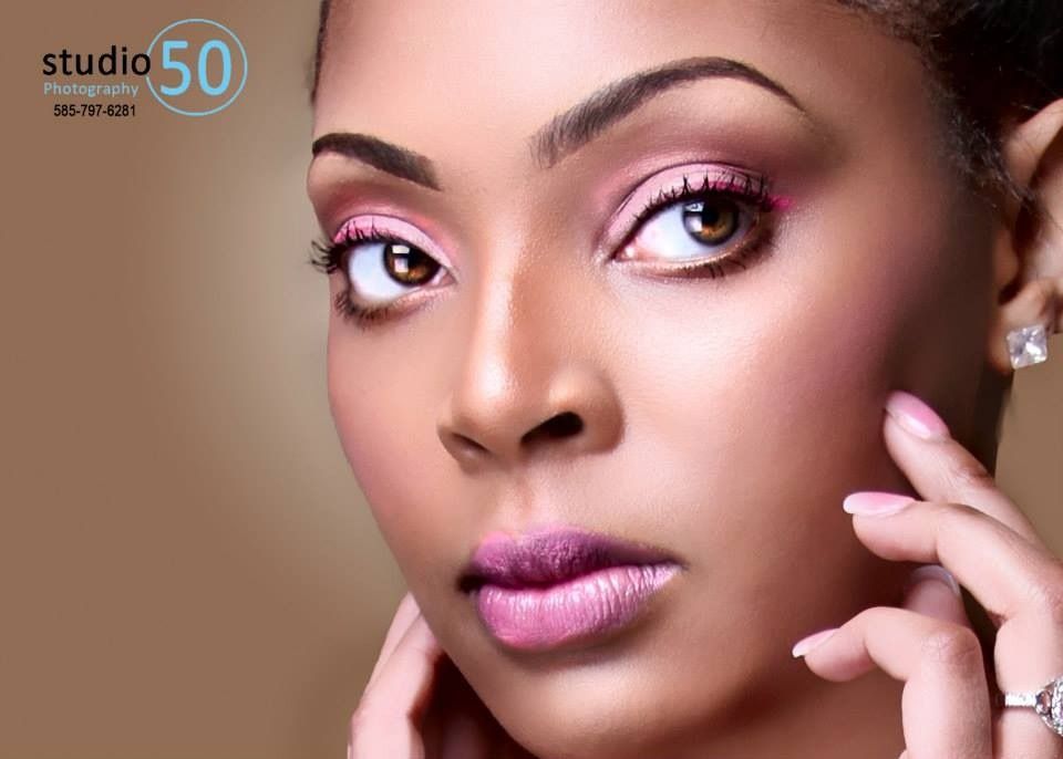 Beauty portrait featuring pink eye makeup and mauve lipstick against a neutral background.