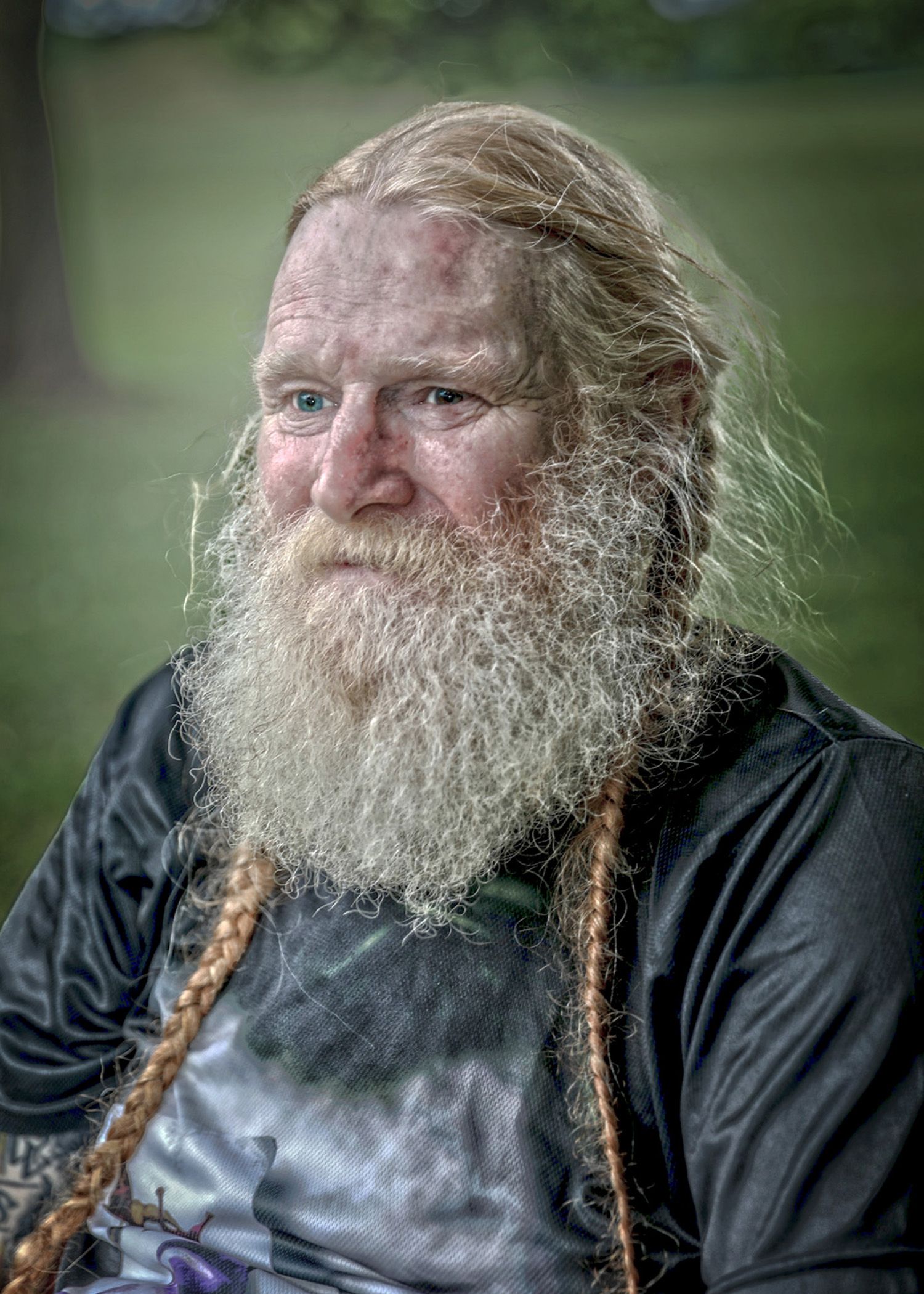 Series of images showing a bearded man with braided facial hair smoking in nature.