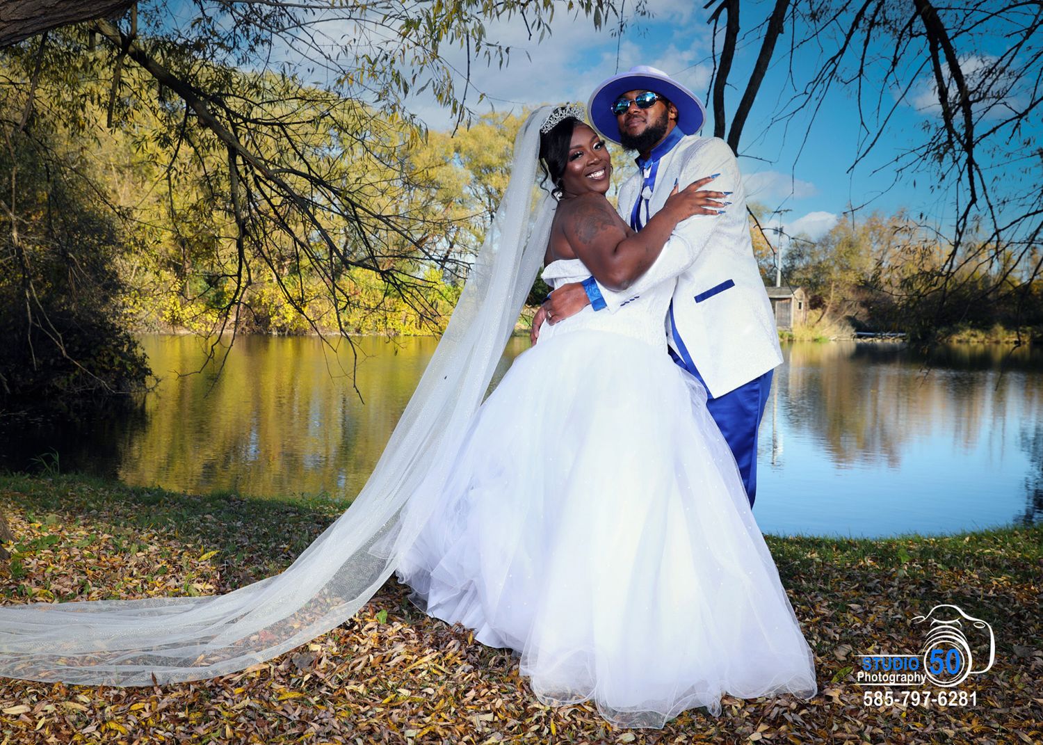Romantic wedding photo series captured in an autumn park setting with fallen leaves and a tranquil lake backdrop.