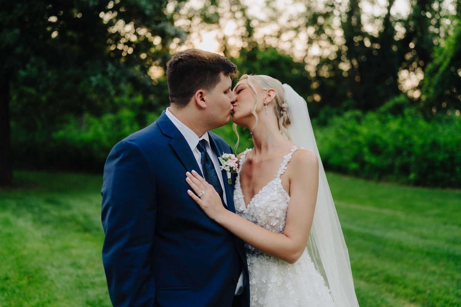Romantic couple sharing tender moments in a lush green garden setting.
