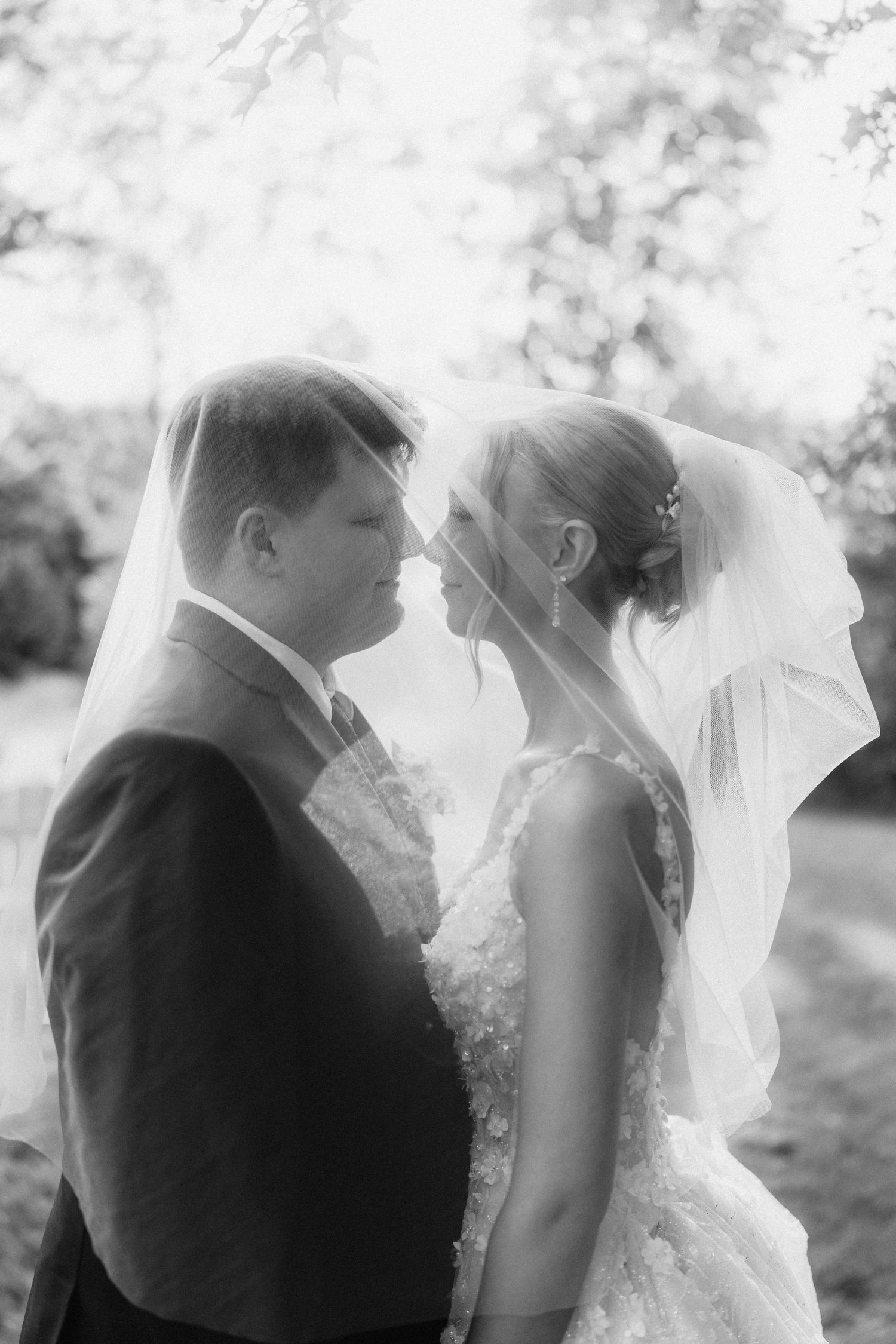 Artistic black and white series showing tender moments between a couple on their wedding day.