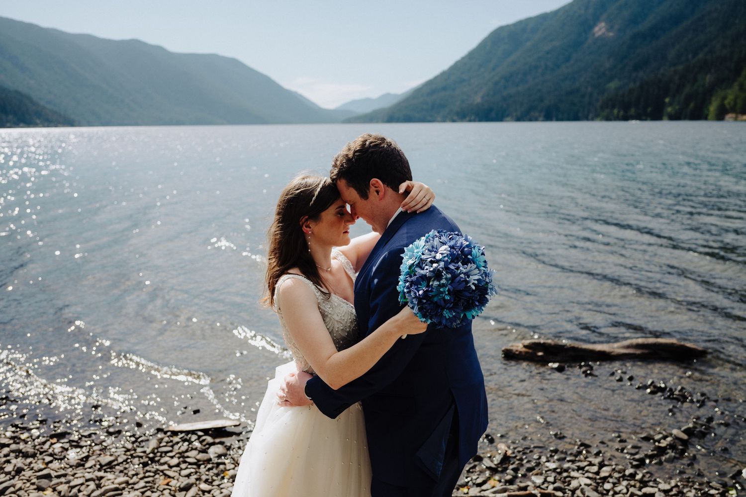 A romantic lakeside moment with sparkling water and mountain views at Lake Crescent.