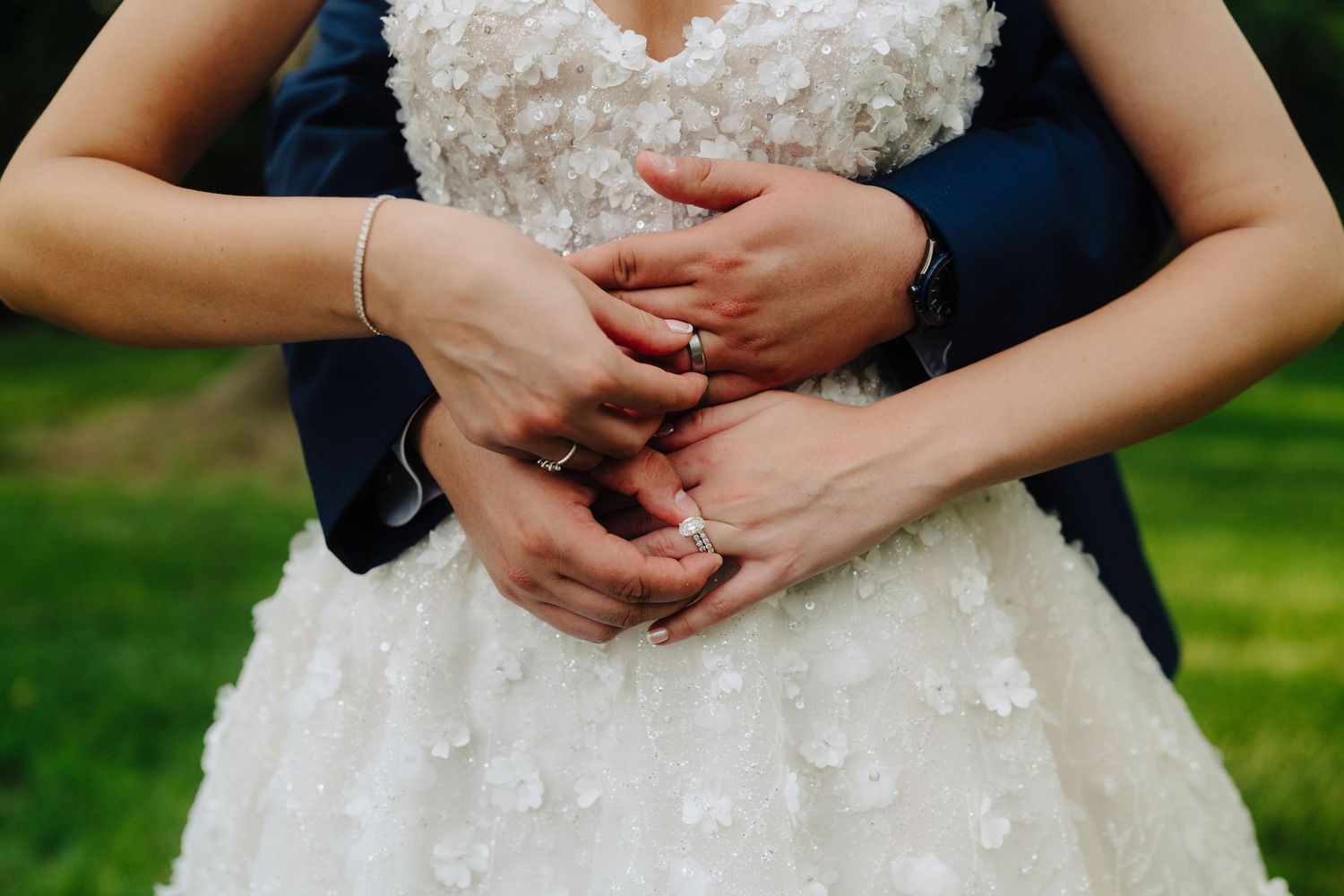 Detail shot of an elegant white wedding dress with intricate beading and lace details.