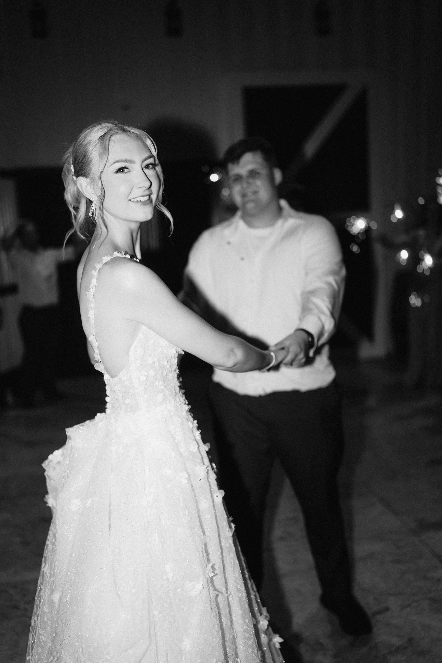 Black and white photos of a wedding celebration with dancing and sparklers at night.