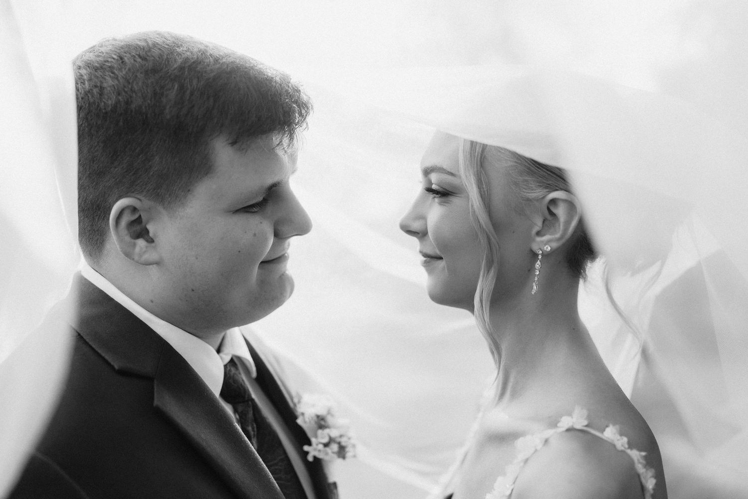 Intimate black and white close-up portrait of a couple sharing a romantic moment.