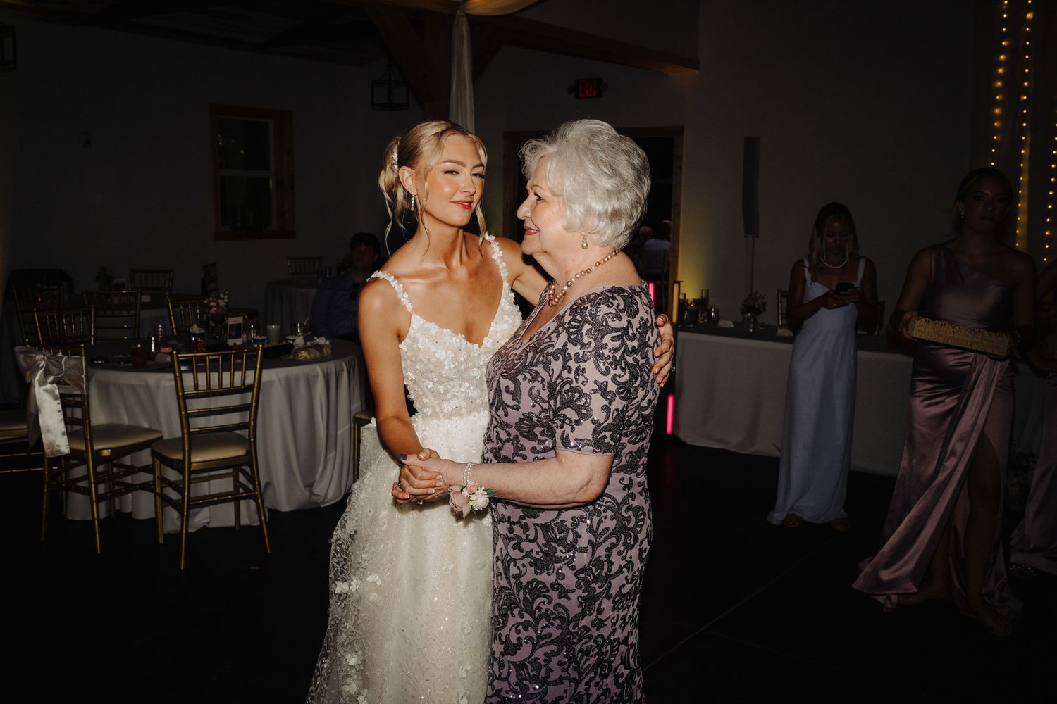 Wedding guests dancing and celebrating during an evening reception.