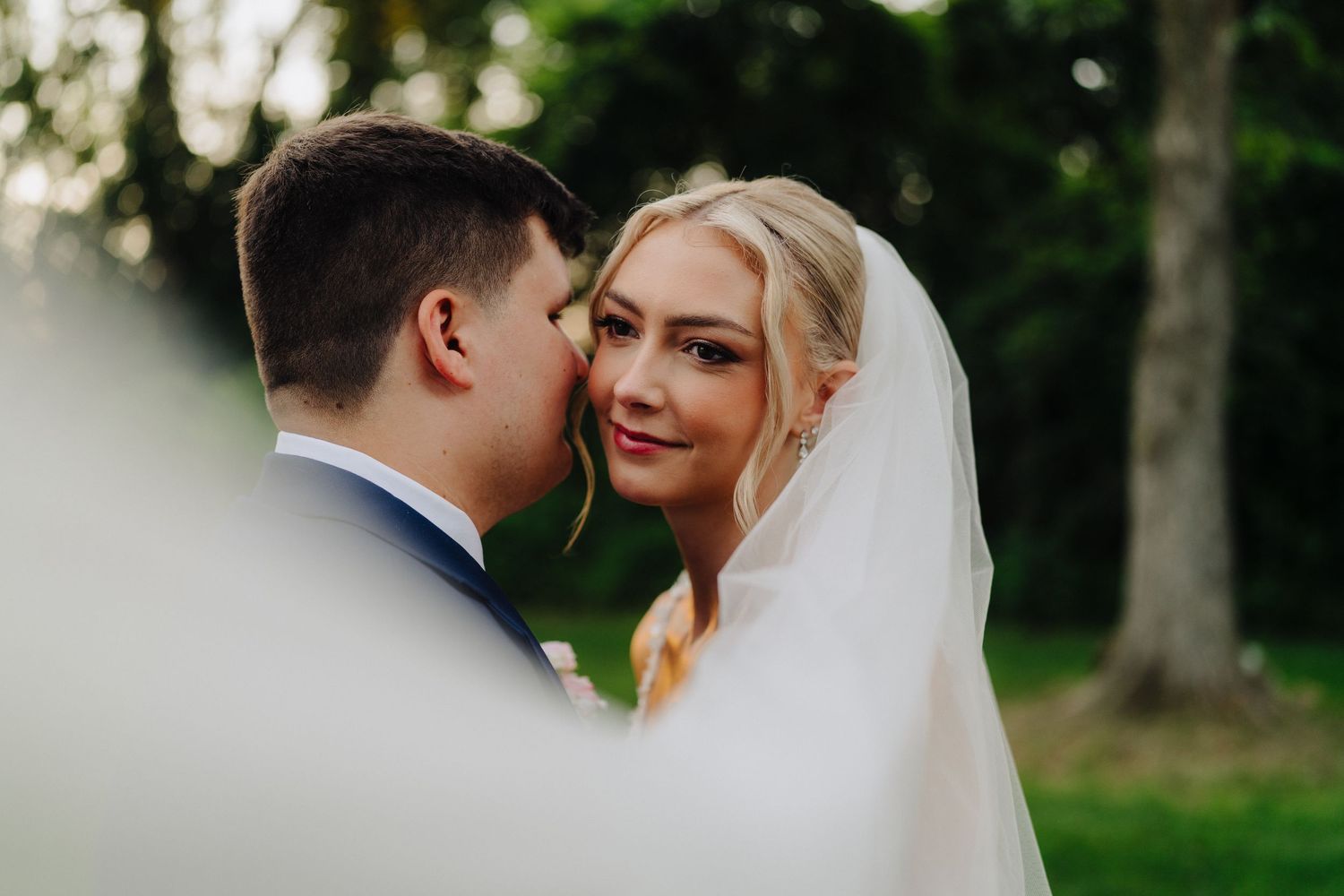 Romantic wedding portraits captured during sunset in garden setting.