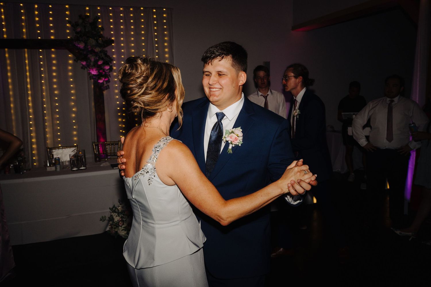 Wedding reception dance floor with string lights creating a romantic atmosphere.