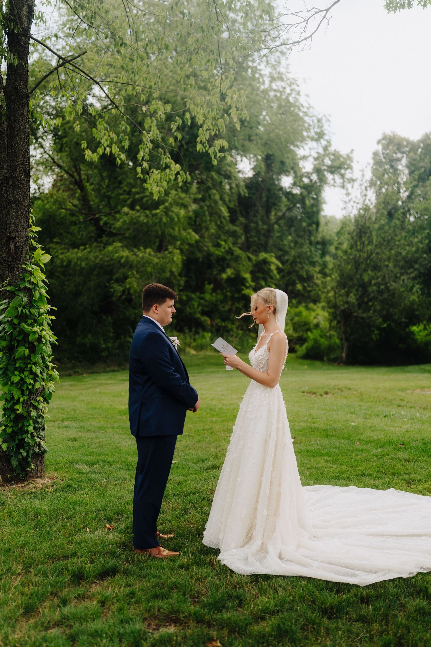Outdoor wedding ceremony with couple exchanging vows in a lush garden setting.