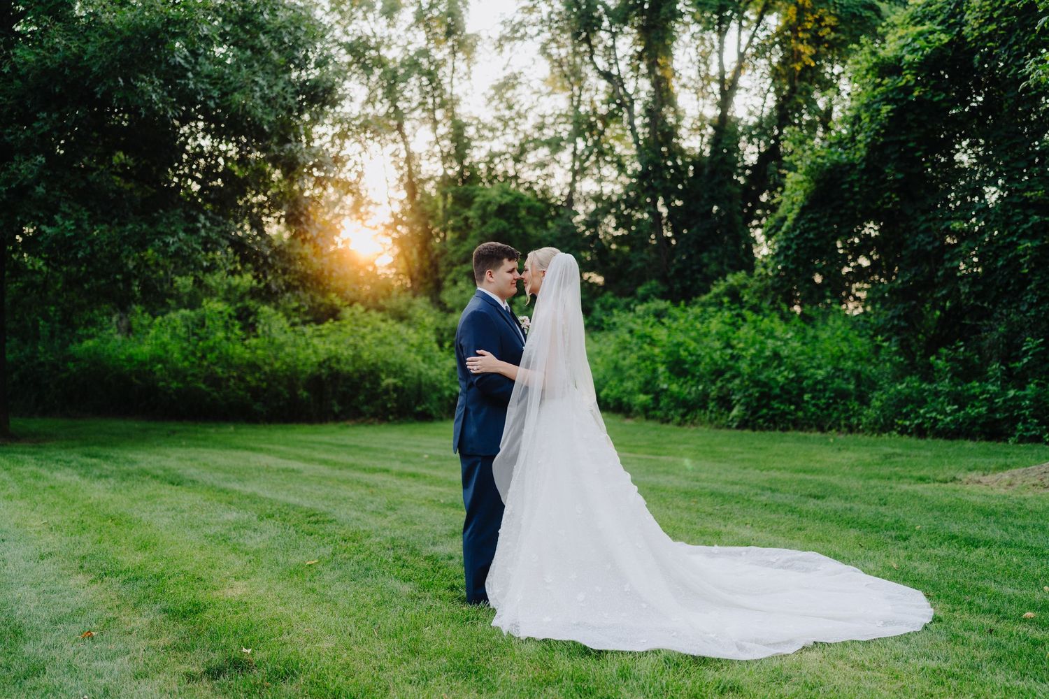 Golden hour wedding portraits captured in lush garden setting.