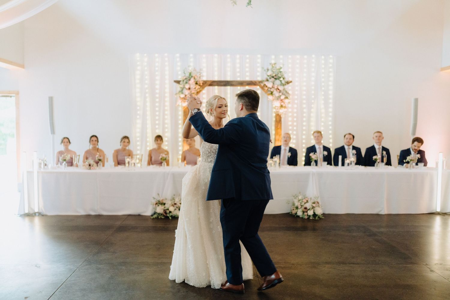 Modern wedding reception venue with white walls and minimalist decor.