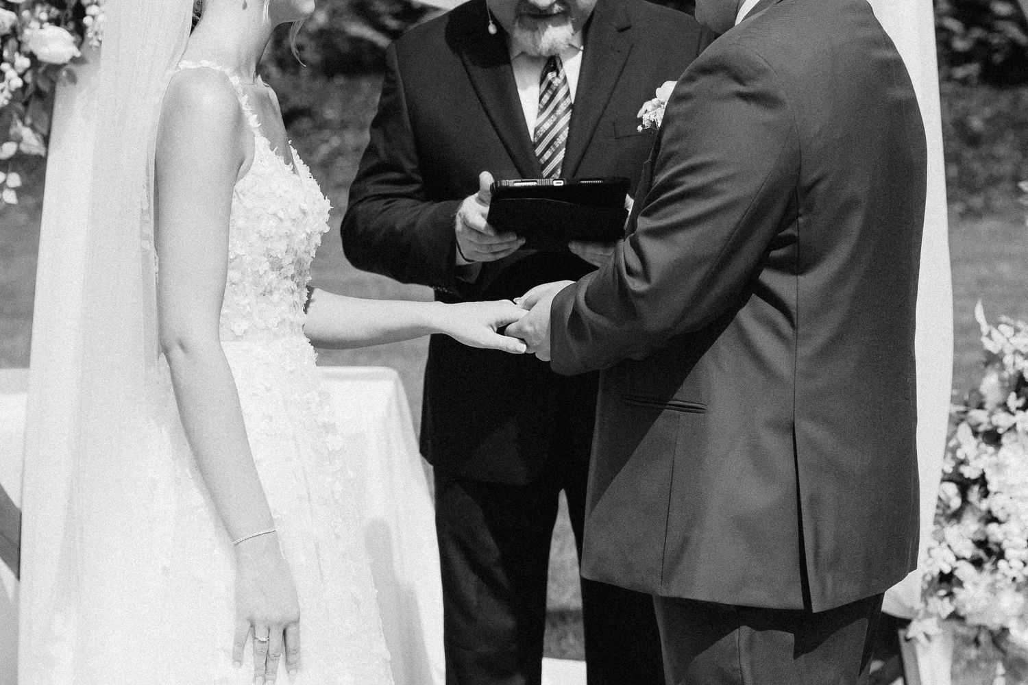 Wedding ceremony moment captured in black and white during the exchange of vows.