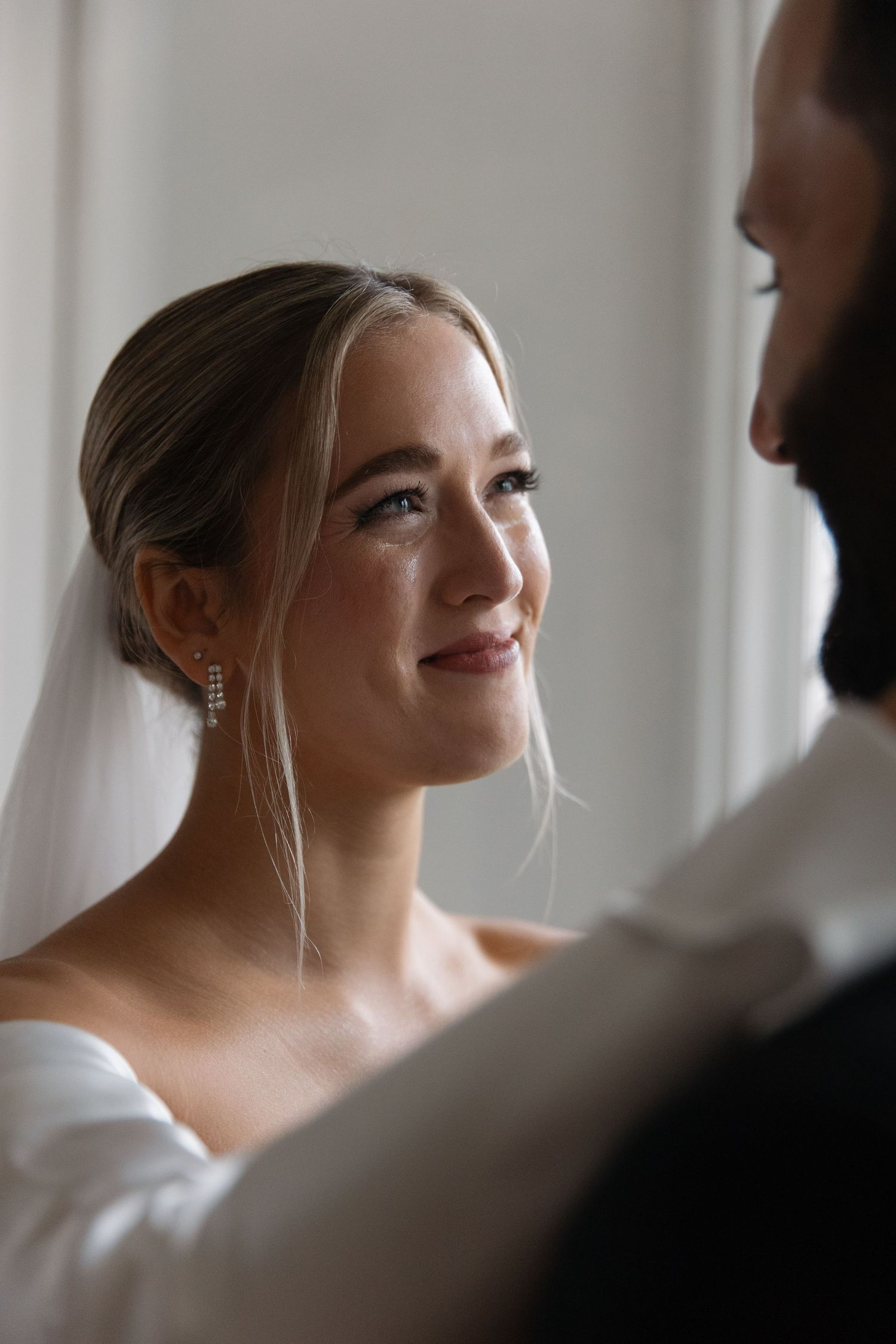 Intimate wedding portrait capturing candid moments between couple.