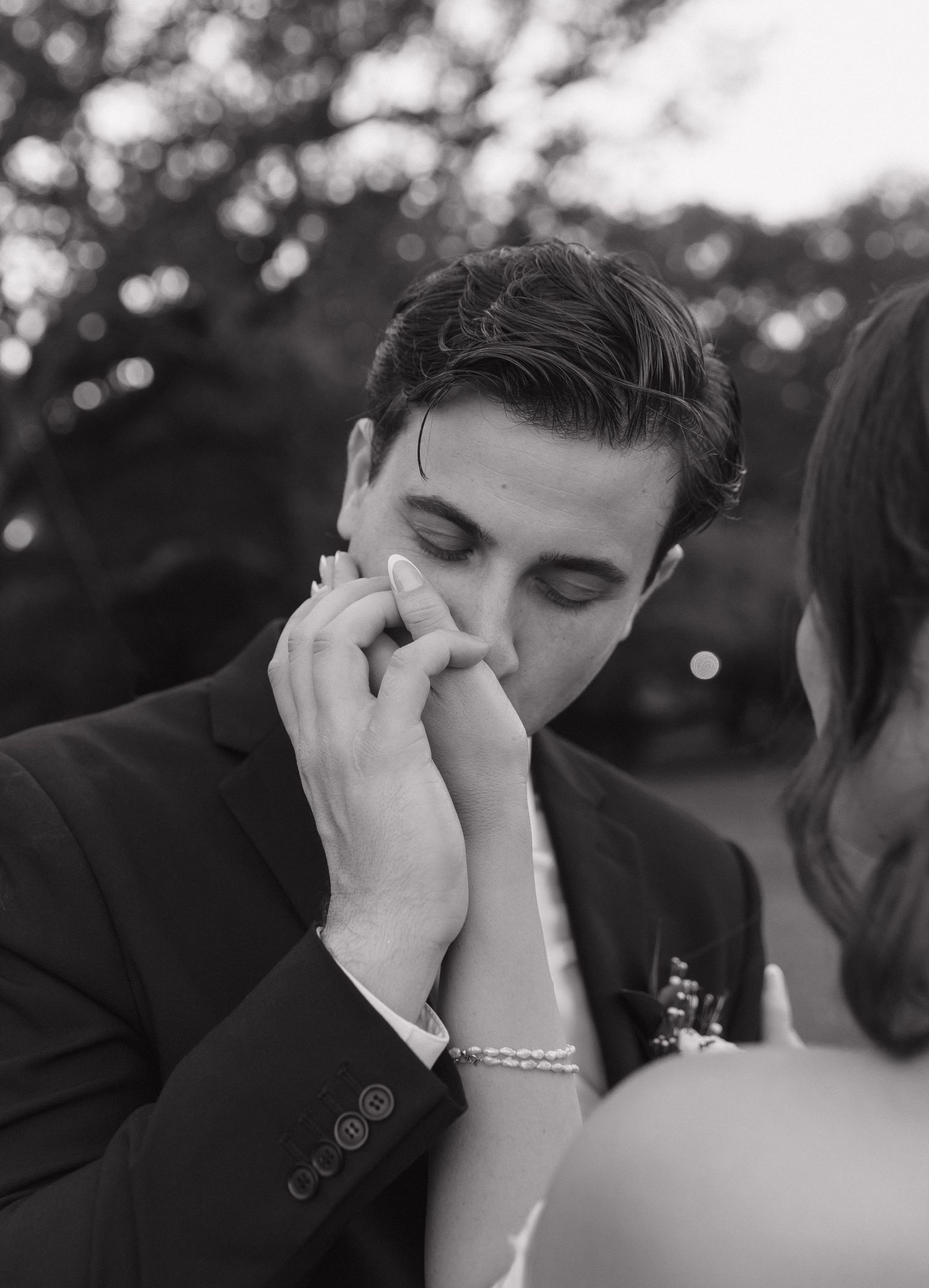 Emotional black and white moment captured during wedding ceremony.