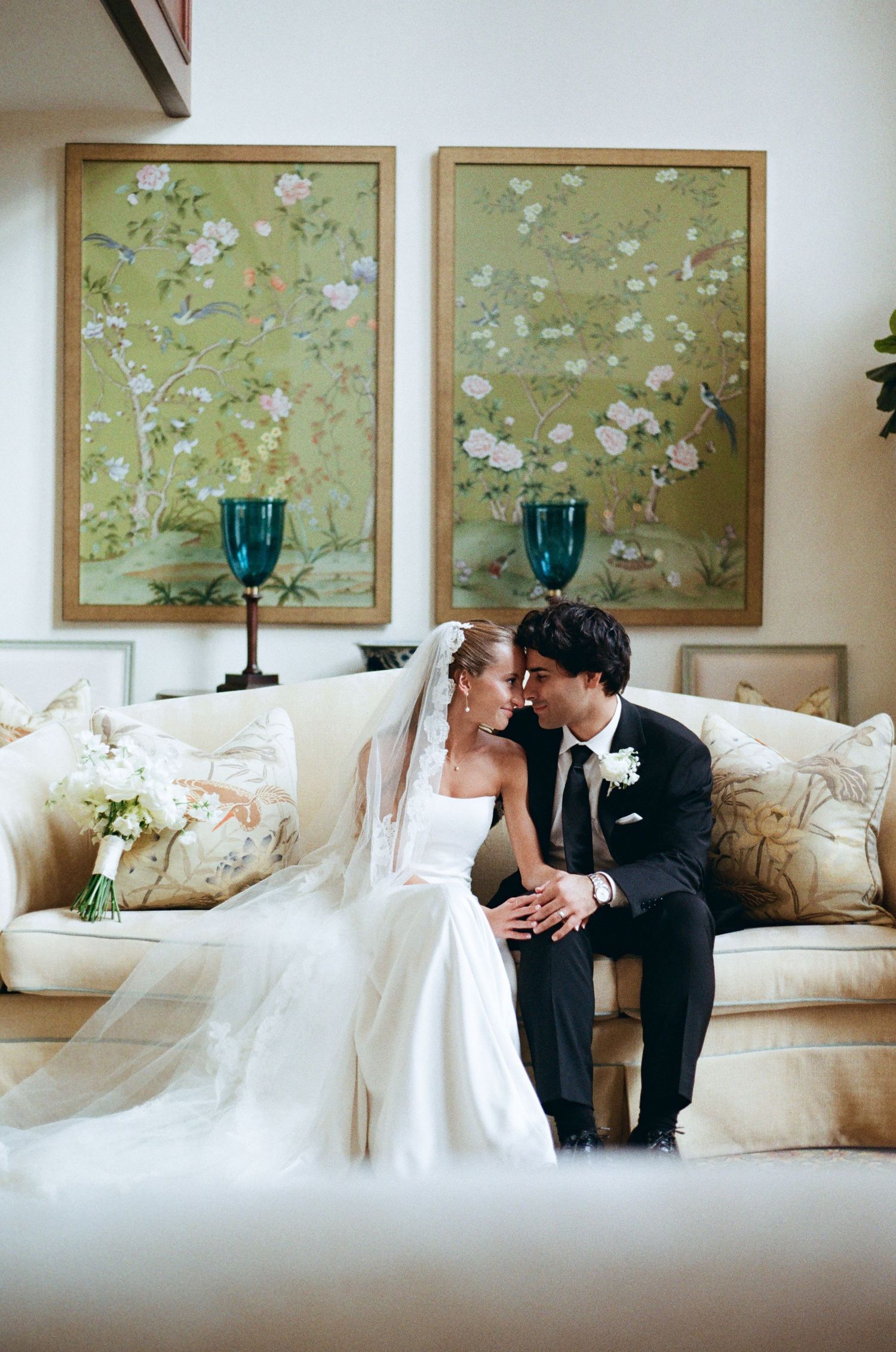 A romantic sequence of wedding photos showing a couple in formal attire sharing intimate moments on an elegant sofa.