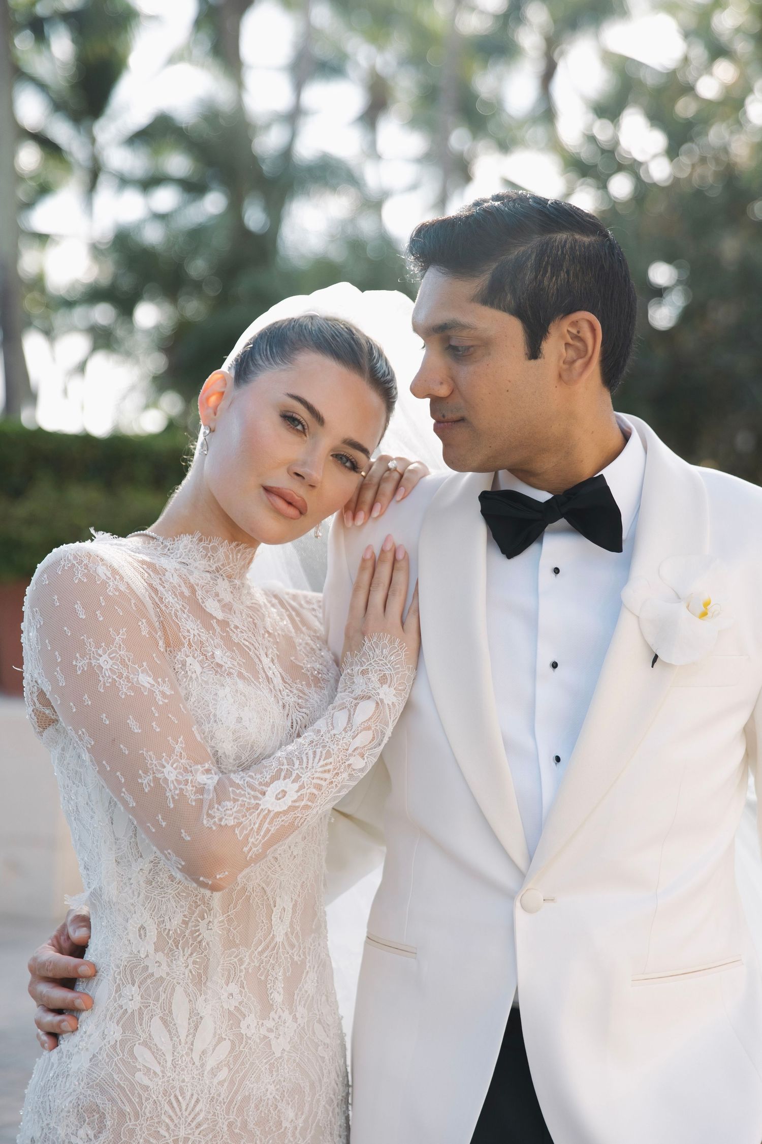 A romantic wedding photo series showing a couple in white formal attire embracing outdoors.