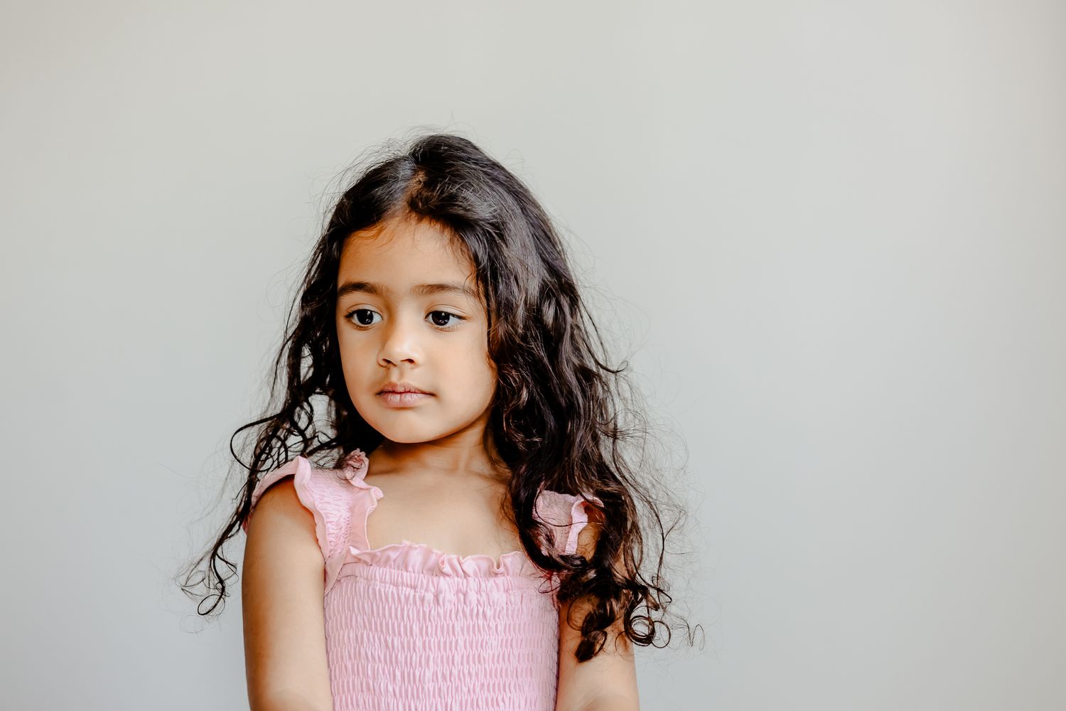 artful Chicago kids portrait session with thoughtful looking down pose