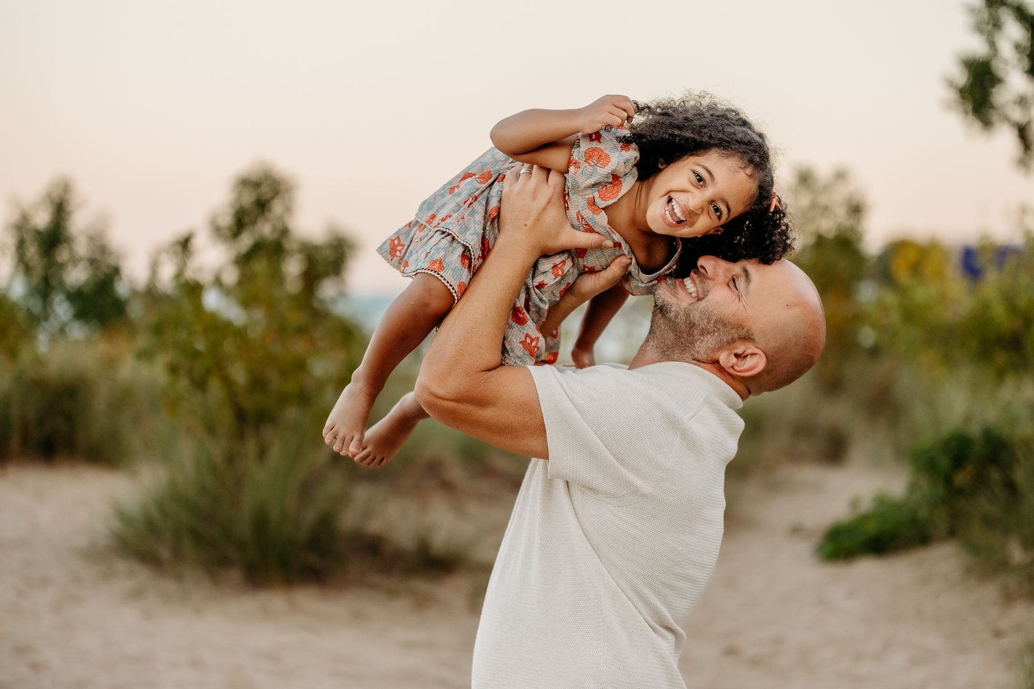 Candid family portrait with parents and children interacting naturally