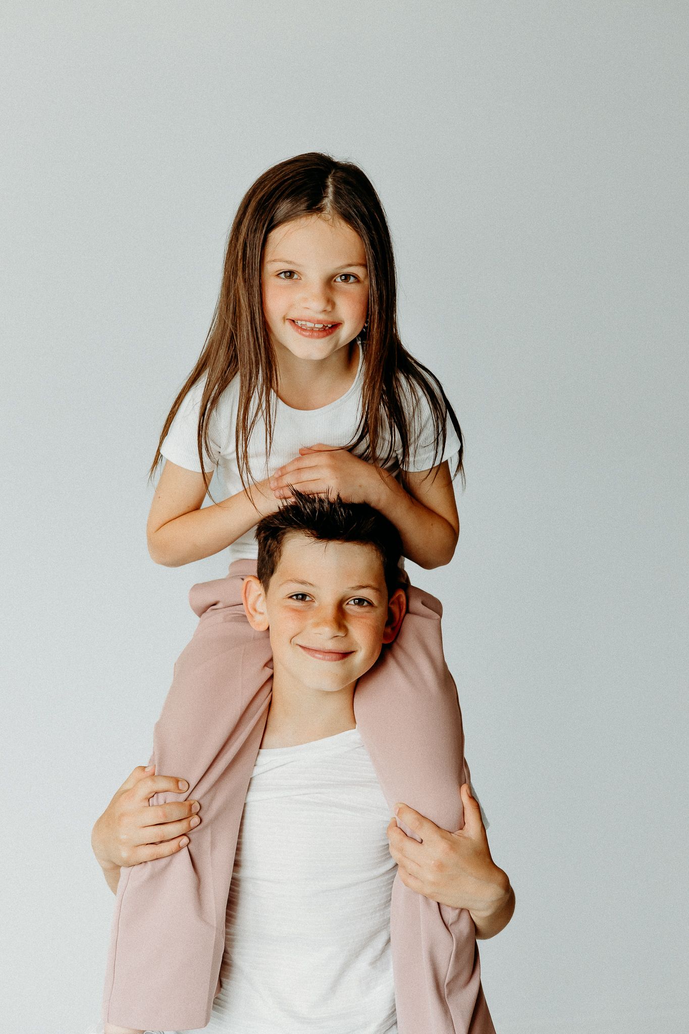 Piggy Back sibling photos in Evanston Chicago Studio