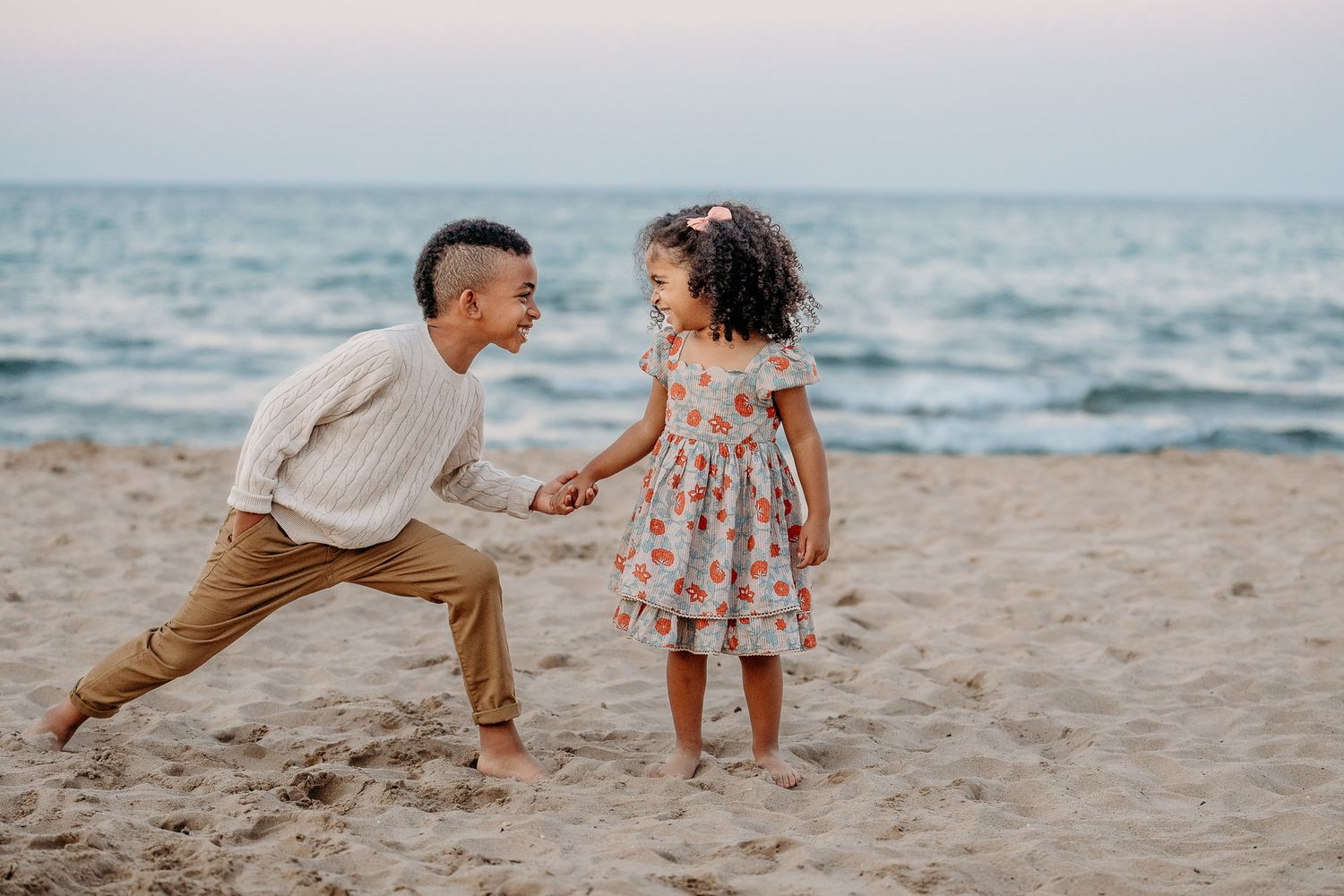 Children playing near the water during a family beach session in Evanston