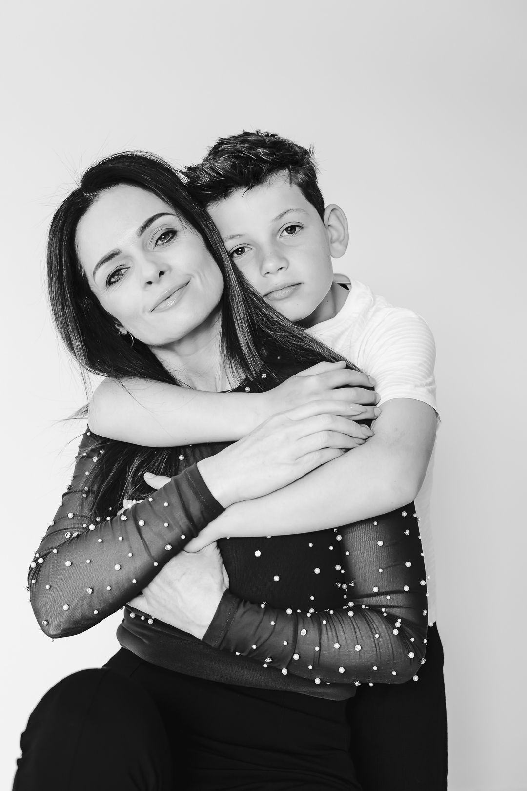 Mom and Son hugging together in North Shore studio portrait session