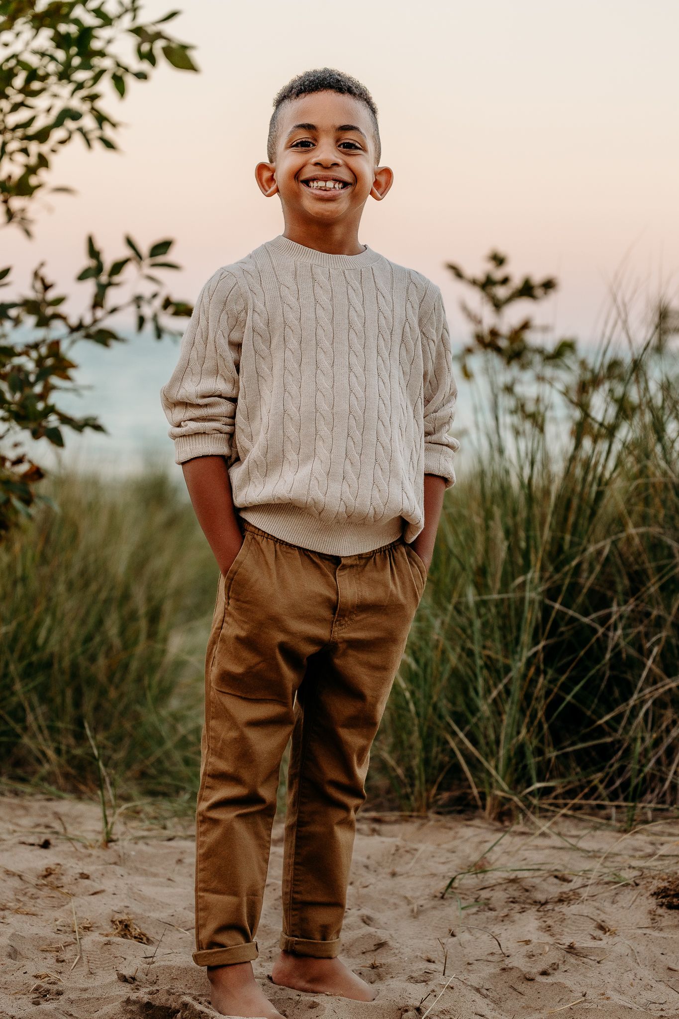 Golden hour family beach portrait with soft light on Lake Michigan shoreline