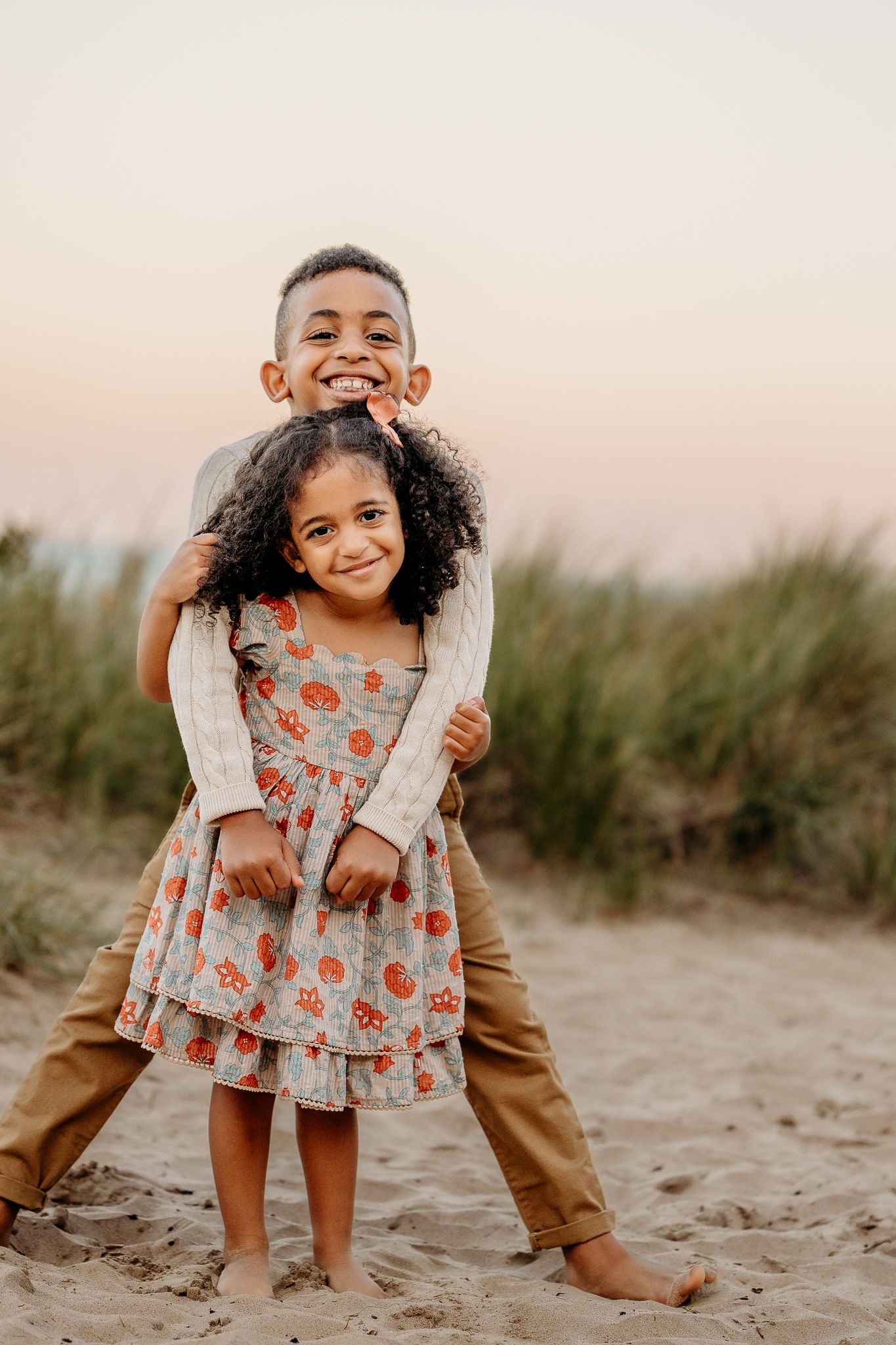Sibling hugging at Chicago family beach session near Lake Michigan
