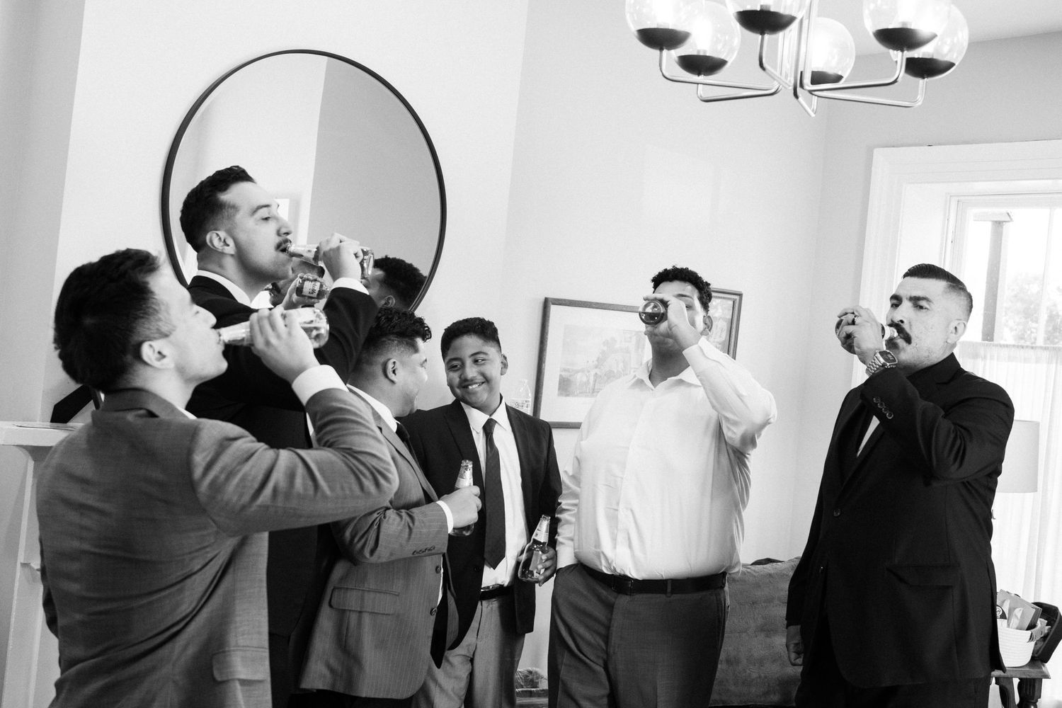 A series of black and white photos showing people drinking from champagne bottles at what appears to be a wedding celebration.