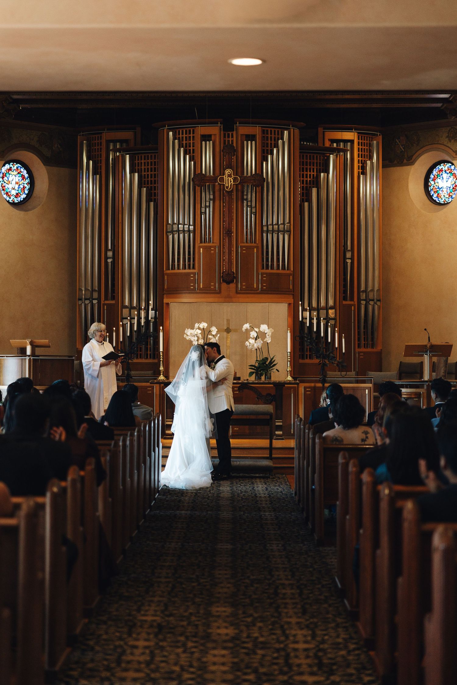 A wedding ceremony sequence showing a bride walking down the aisle in a church with wooden pews and a pipe organ.