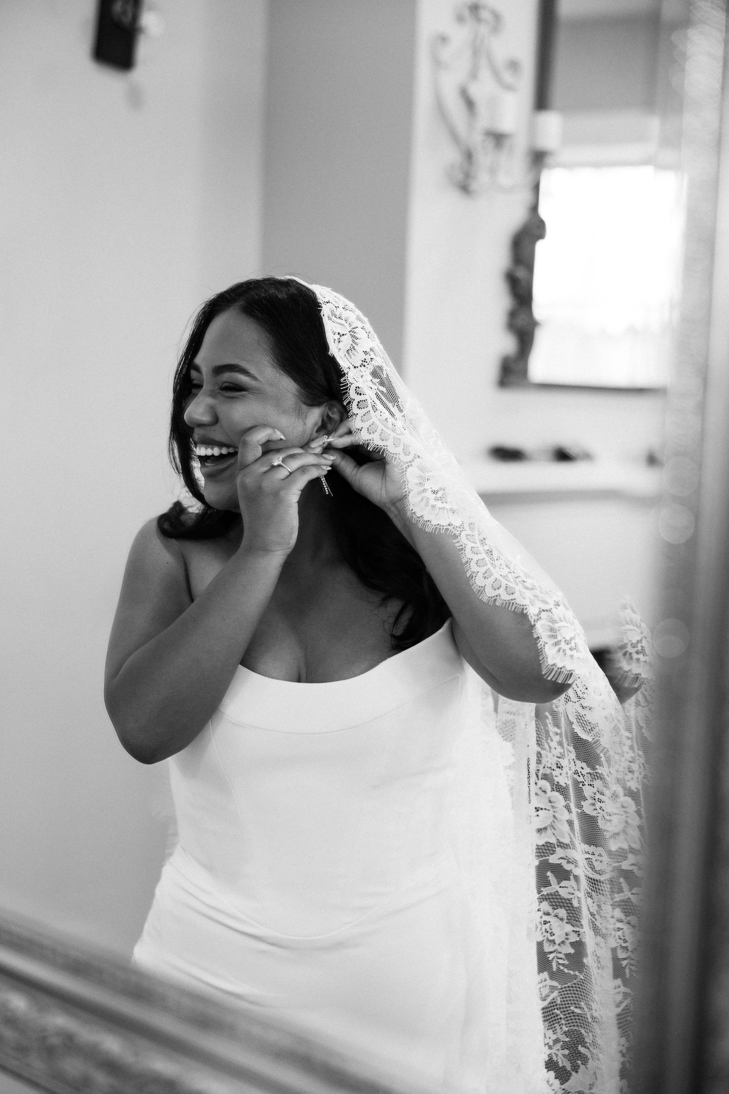 A sequence of black and white photos shows a bride in a white gown and veil laughing joyfully during a candid moment.