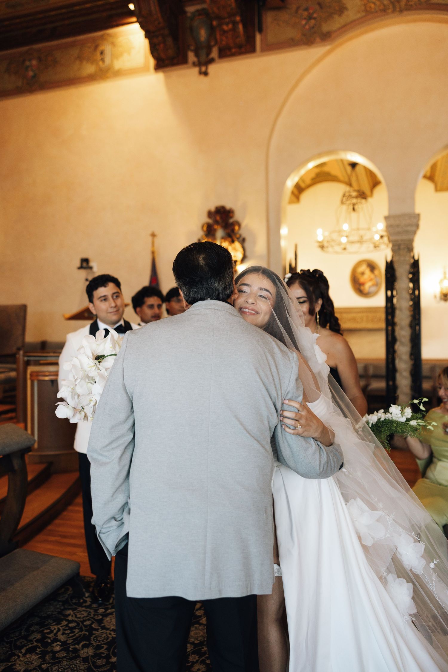 A sequence of wedding photos showing the couple dancing and embracing in an elegant indoor venue.