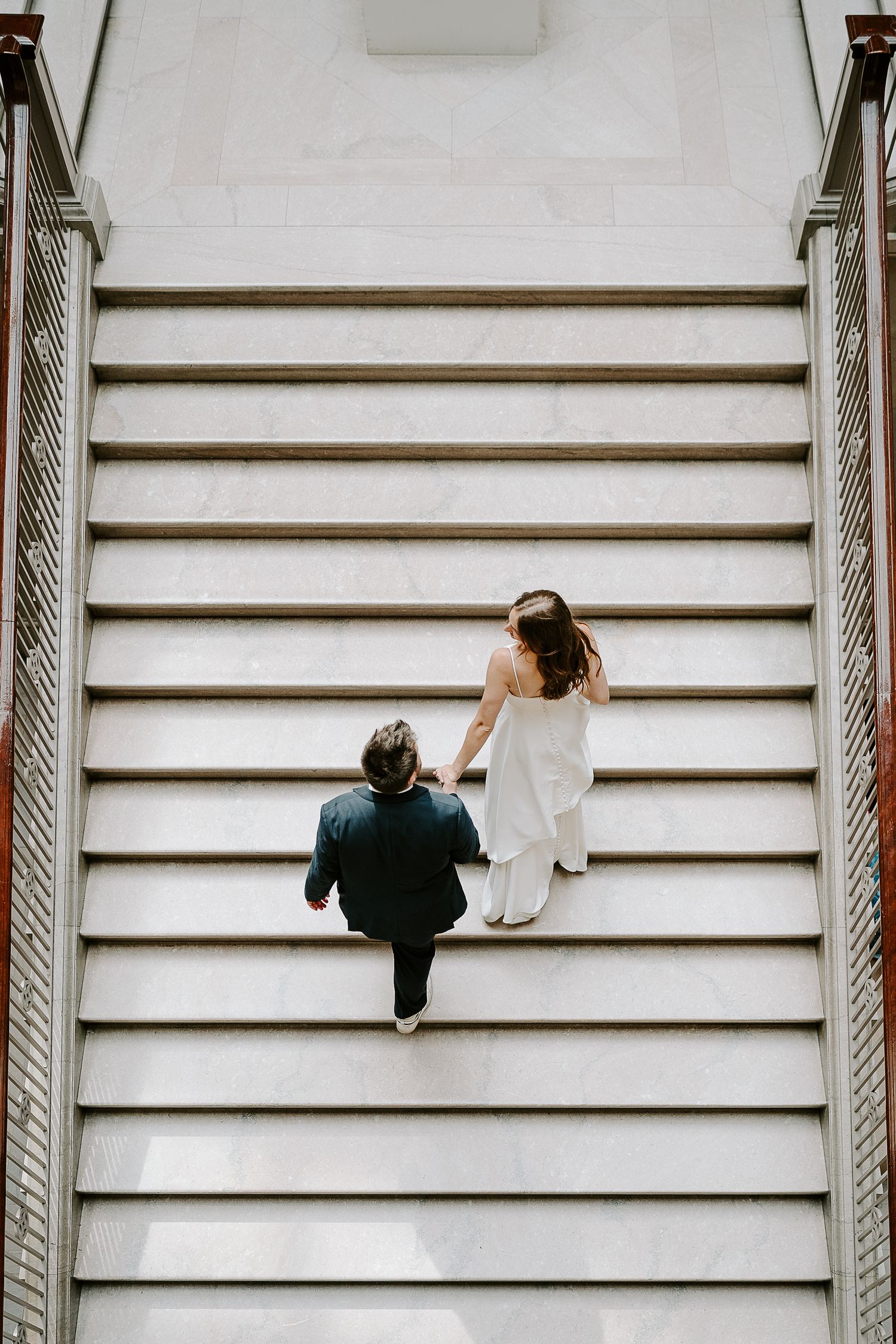 Modern architectural wedding photo shoot on white stairs.