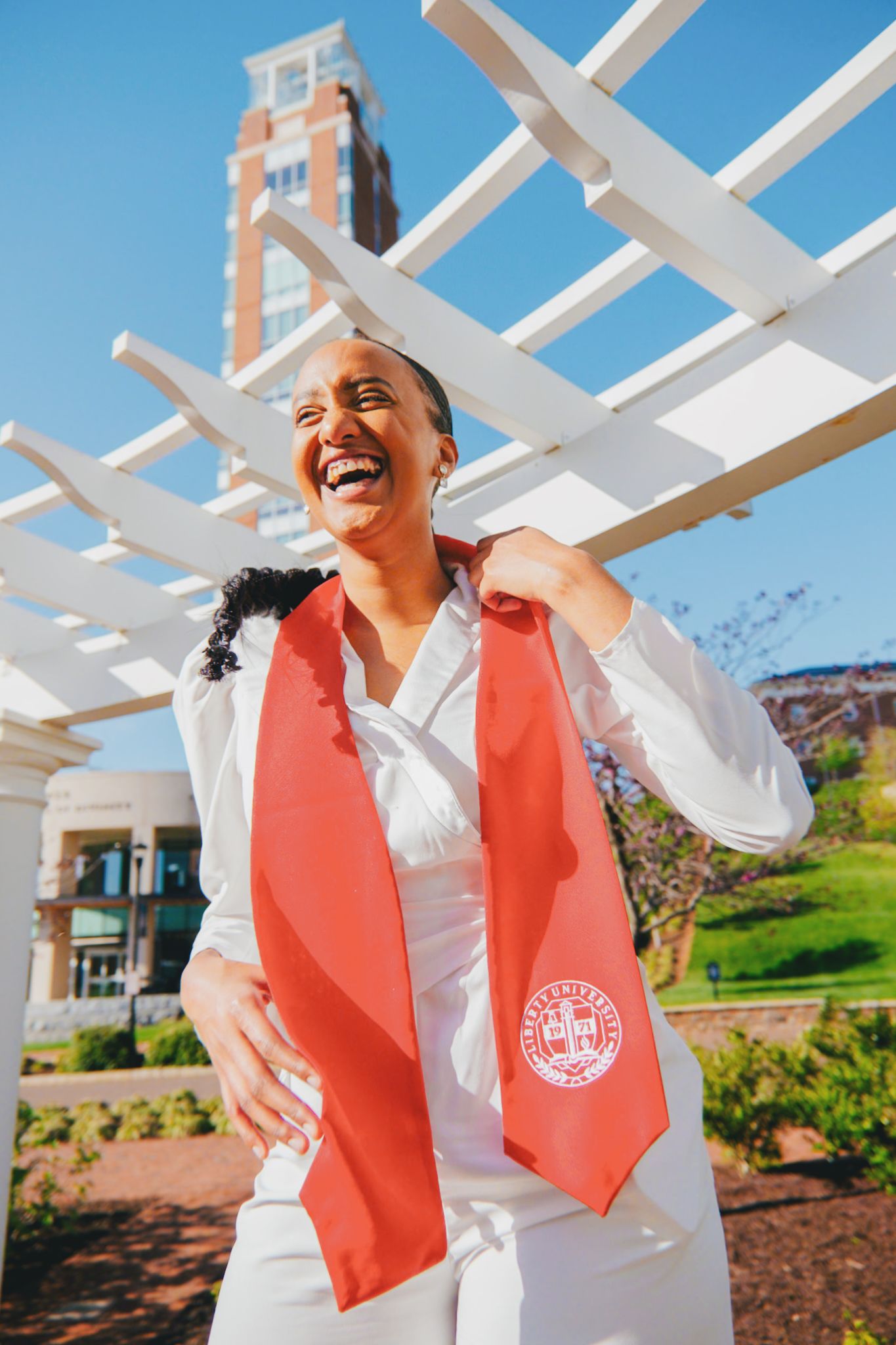 A series of four photos showing someone in a white shirt and coral vest laughing joyfully under a white pergola structure.