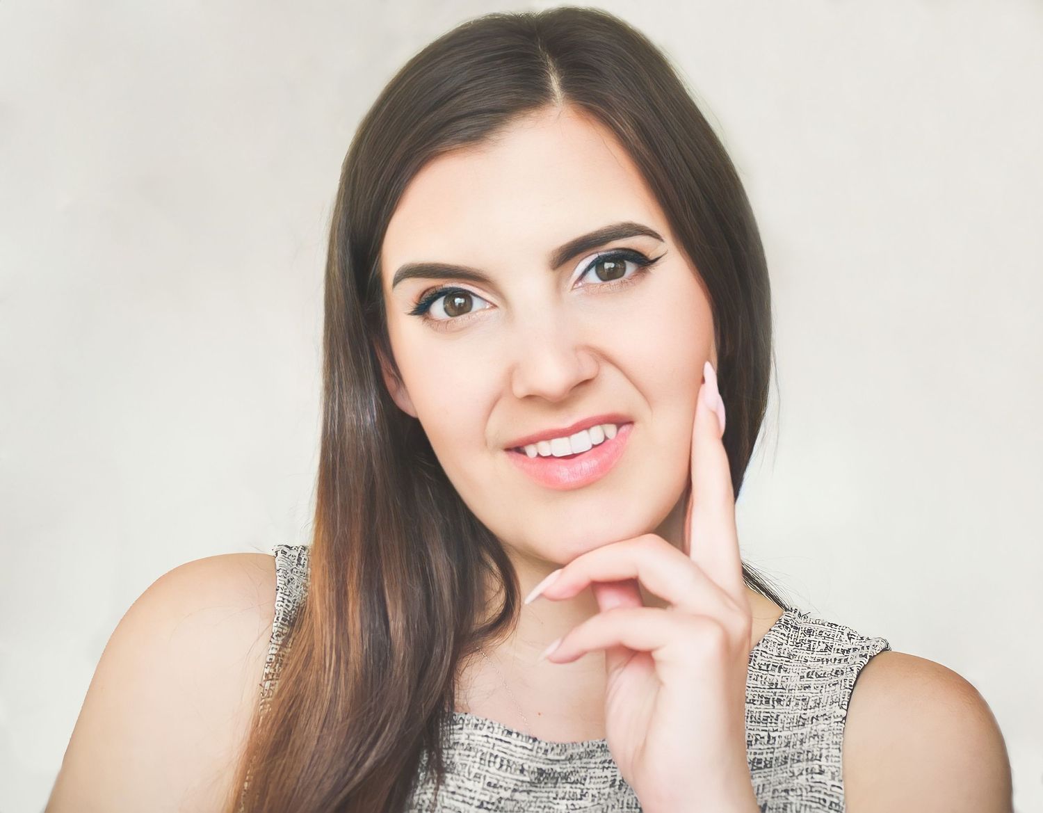 A headshot photo of Corrin Alexander. Her face is resting in her hand.