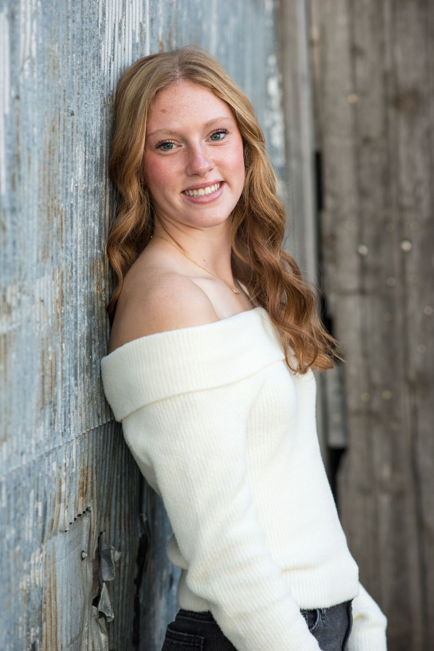 High school senior girl smiling during outdoor portrait session in Gretna, Nebraska.