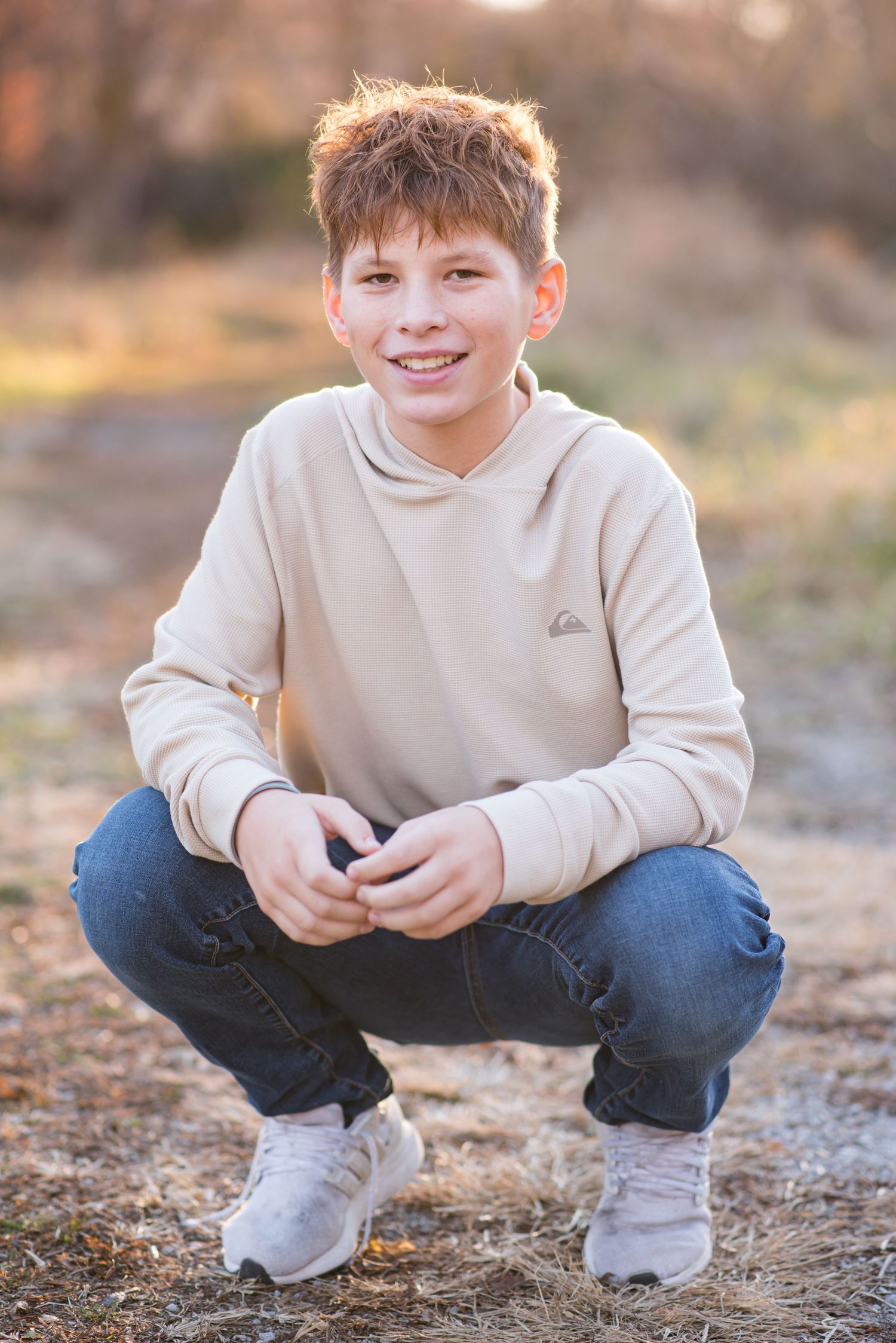 Young msn standing and smiling during an outdoor photoshoot in Omaha, NE.