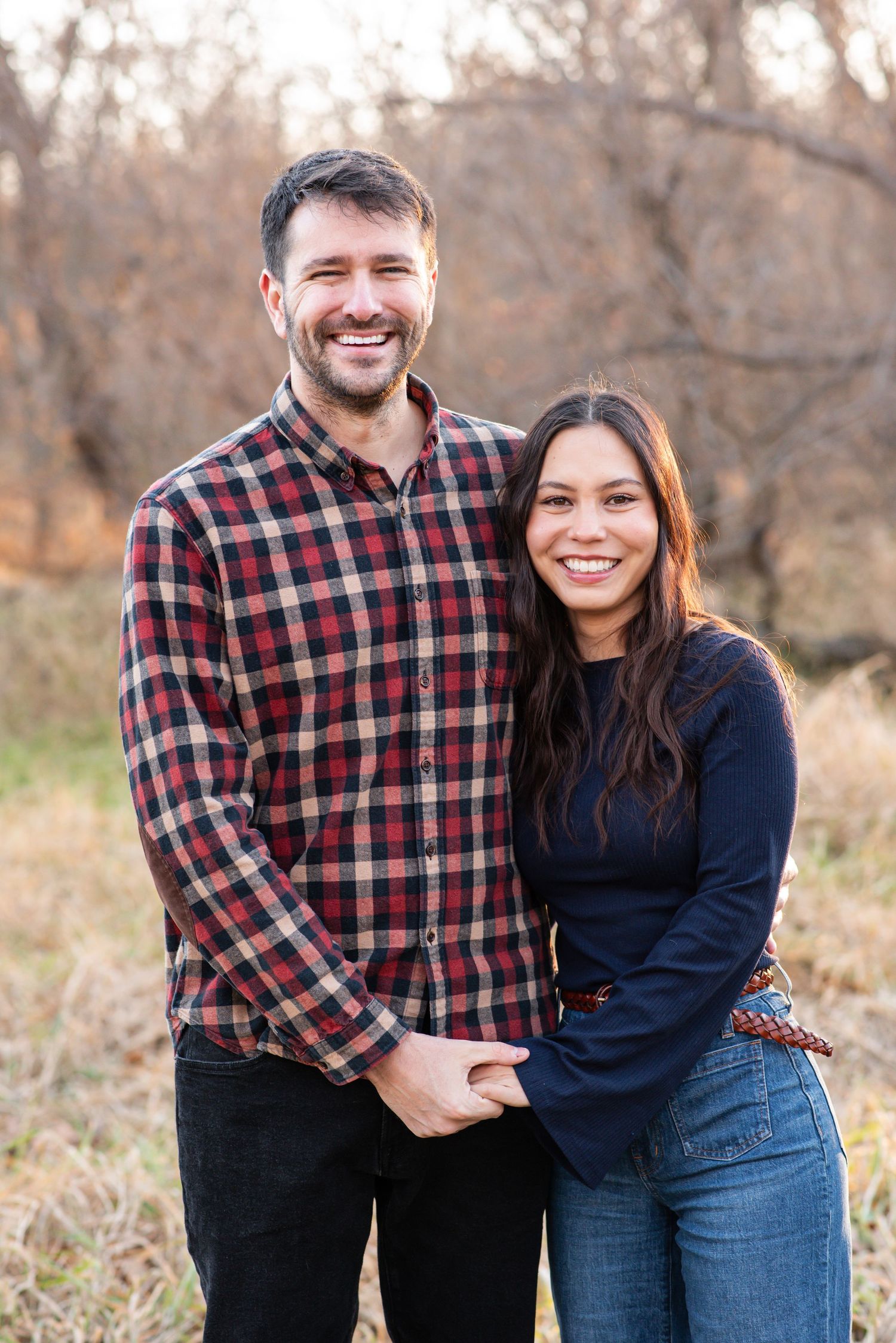 Couple smiling and standing together during outdoor session in Gretna, Nebraska.