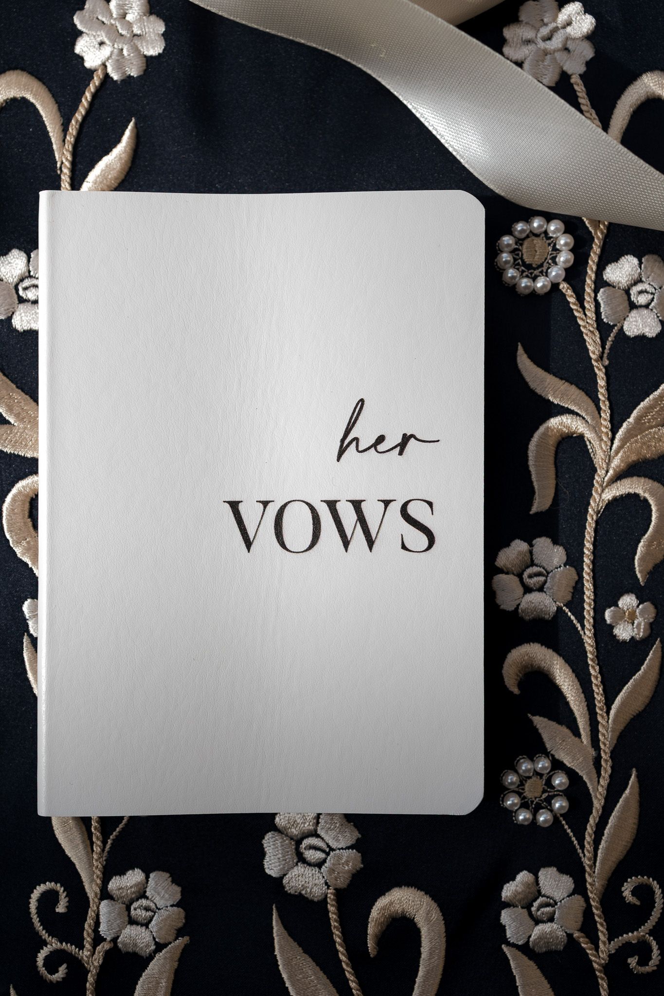 White wedding vow booklet labeled 