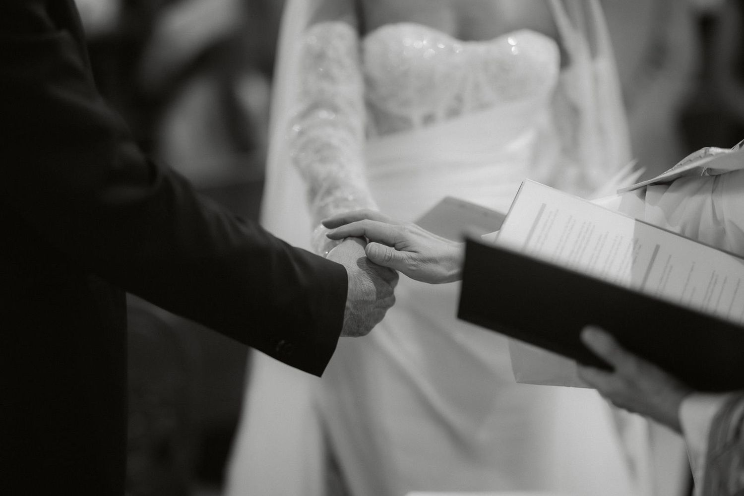 Black and white images of hands exchanging wedding rings during a ceremony.