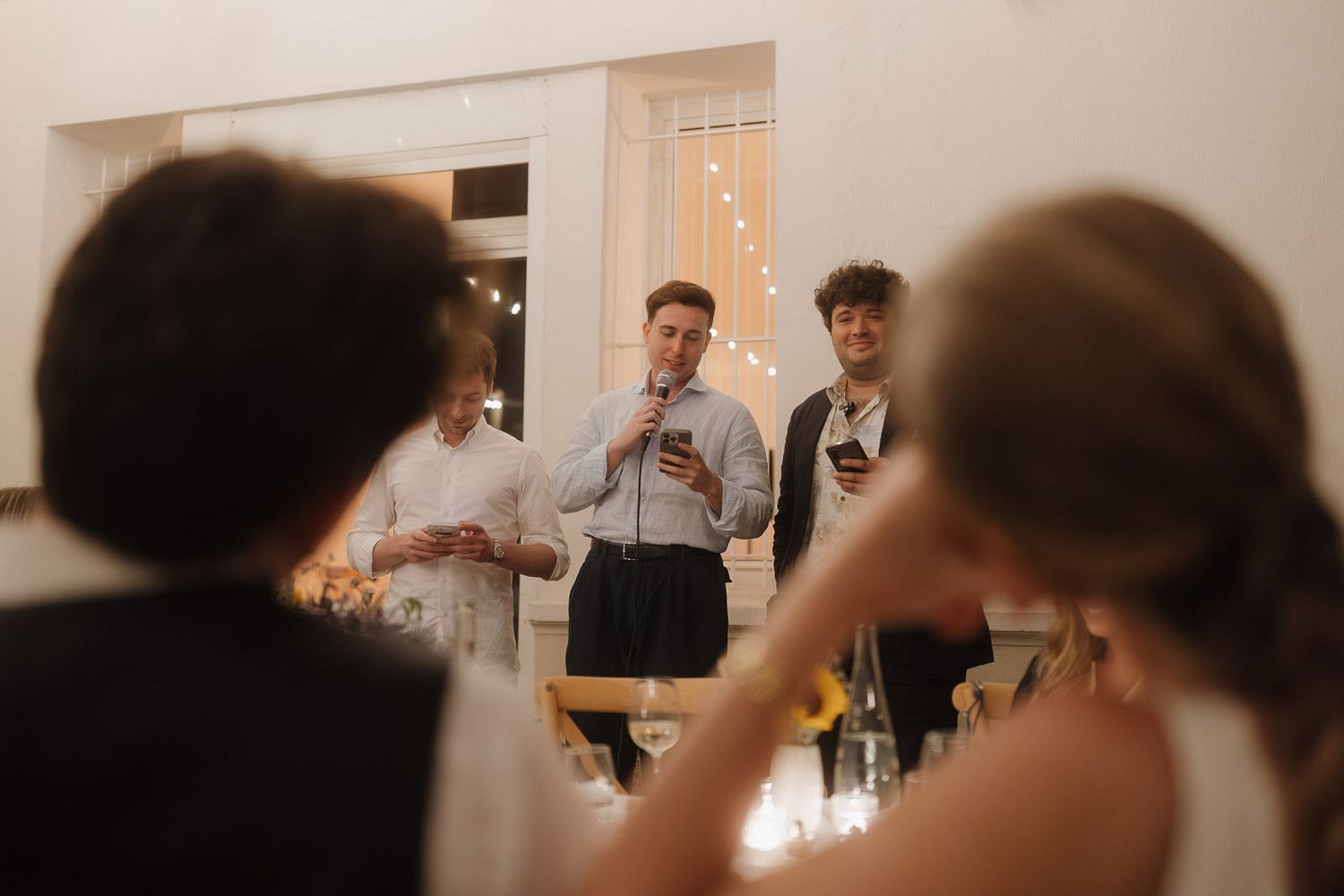 A series of blurred motion shots showing people moving and interacting in a white interior space.