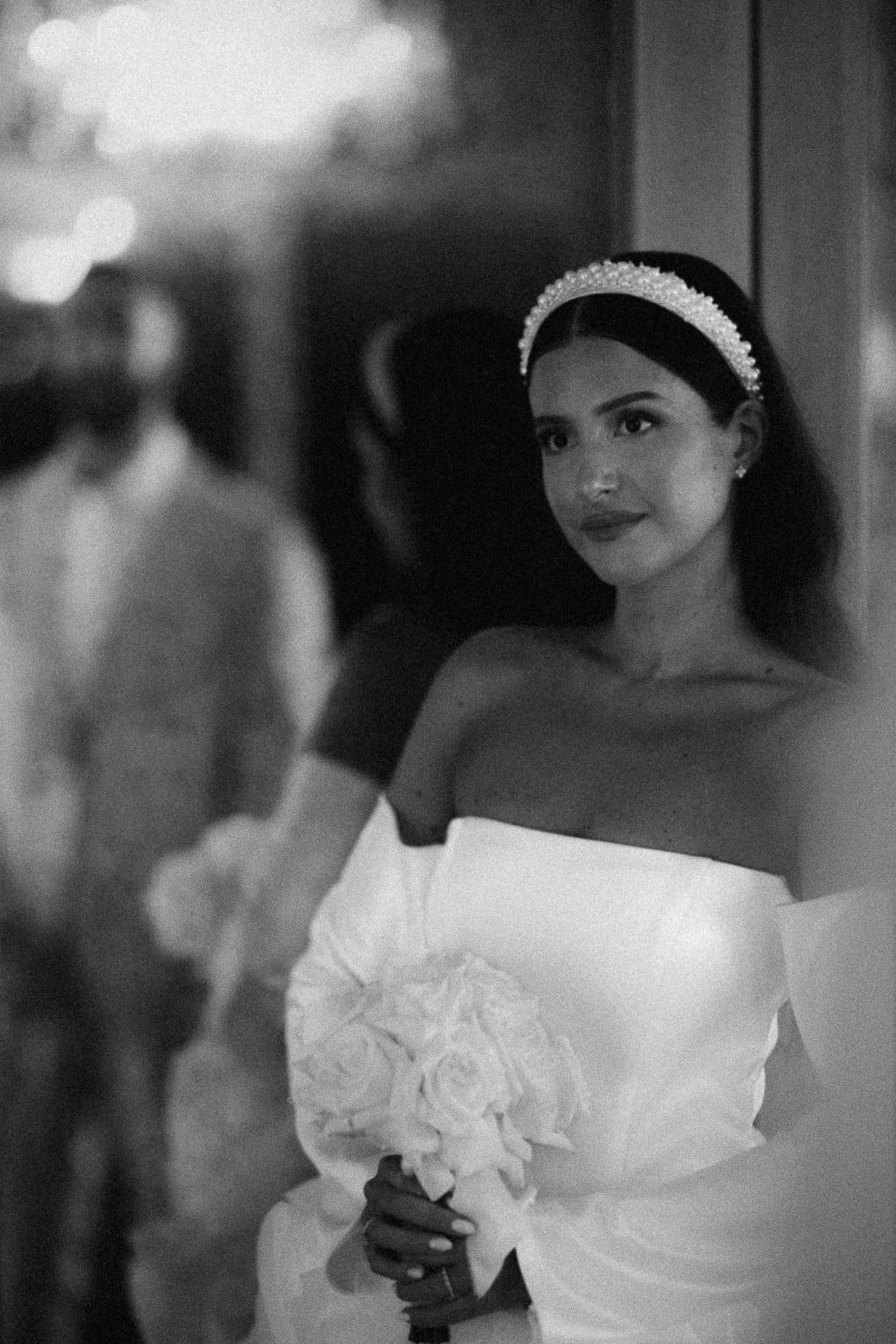 A series of black and white wedding photographs showing a bride in an elegant white dress with ruffled details.