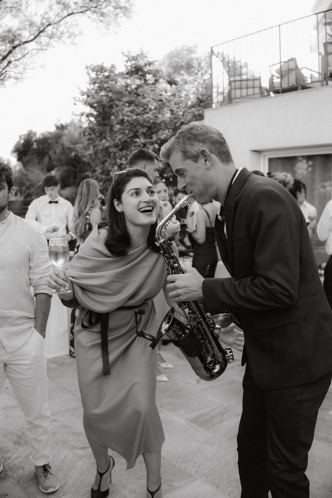 A series of black and white photos showing couples dancing together at an outdoor event.