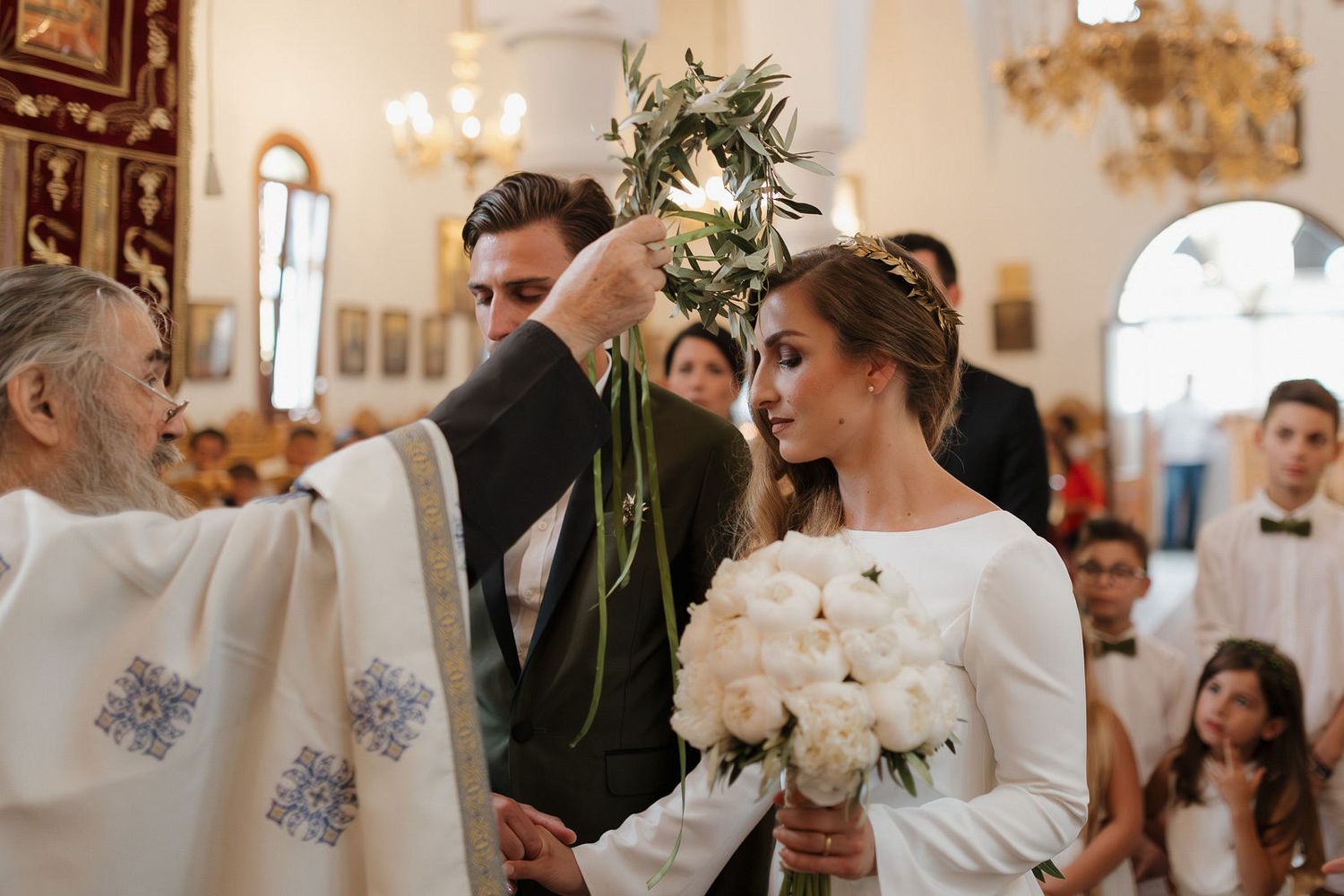 A series of wedding ceremony moments showing people exchanging rings and vows in an elegant church setting.